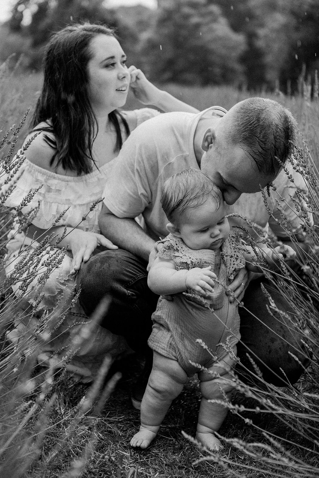 outdoor family photo of three. raining photoshoot in nashville tennessee. black and white photo
