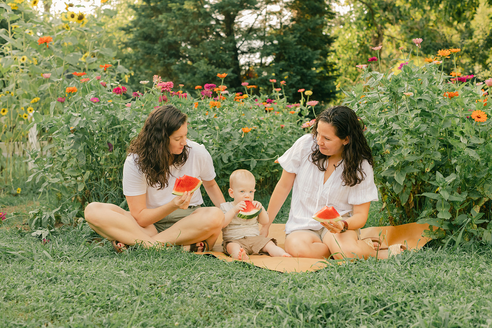 outdoor motherhood minis in garden. photographed in nashville photographer. two moms and their baby
