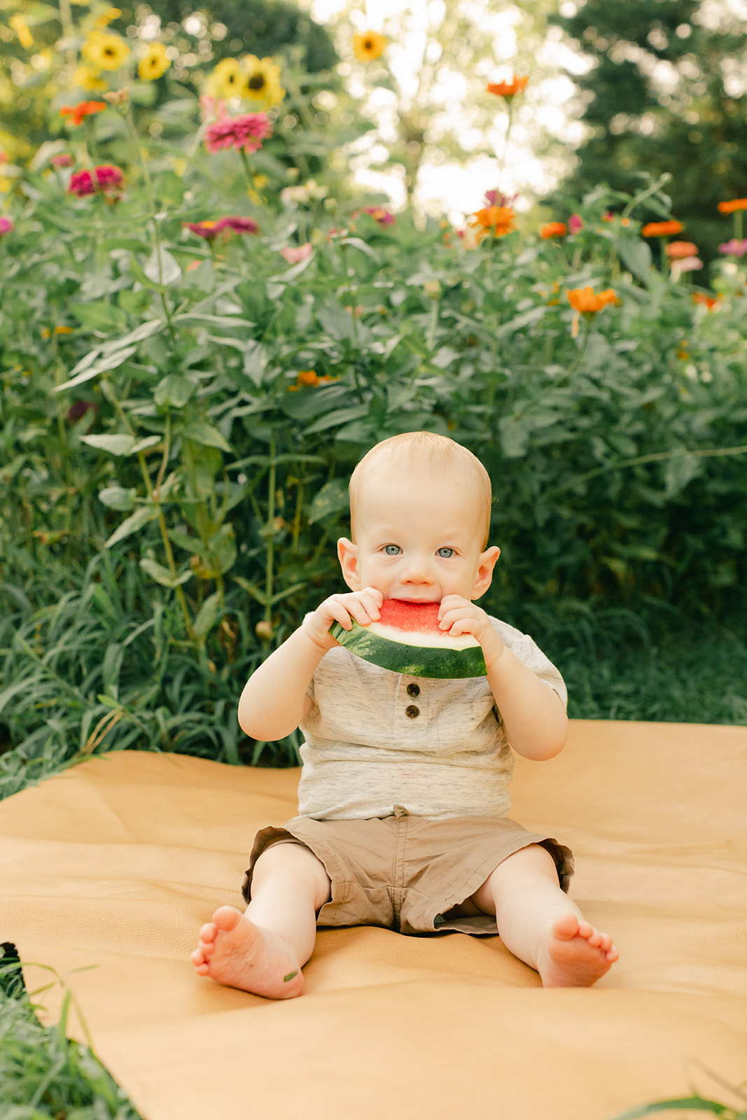 outdoor motherhood minis in garden. photographed in nashville photographer. little boy eating watermelon