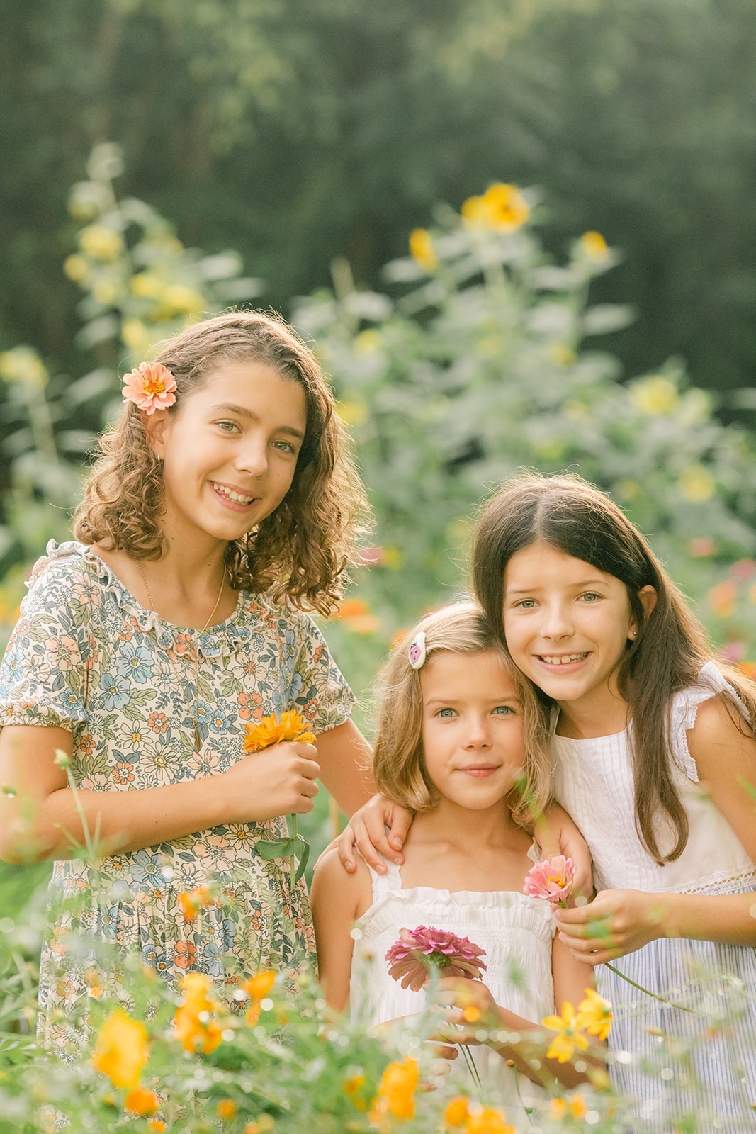 outdoor motherhood minis in garden. photographed in nashville photographer. three sisters