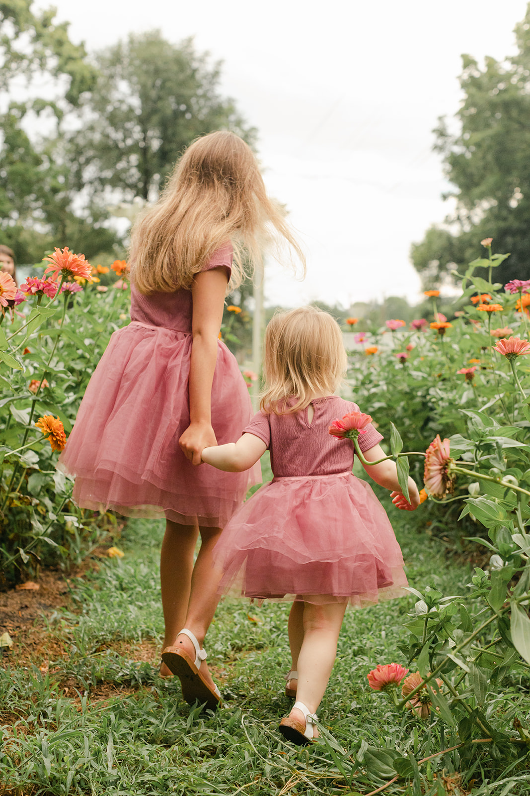 outdoor motherhood minis in garden. photographed in nashville photographer. two little sisters