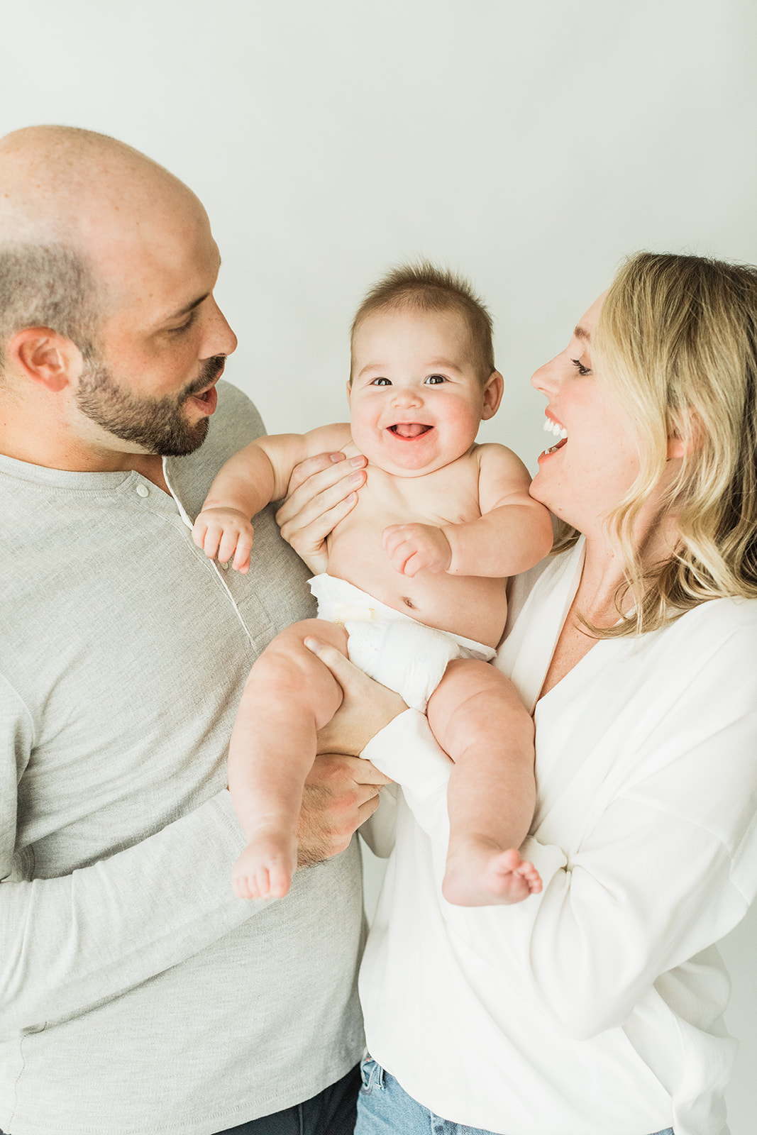 6 month milestone session in nashville studio. parents with baby boy