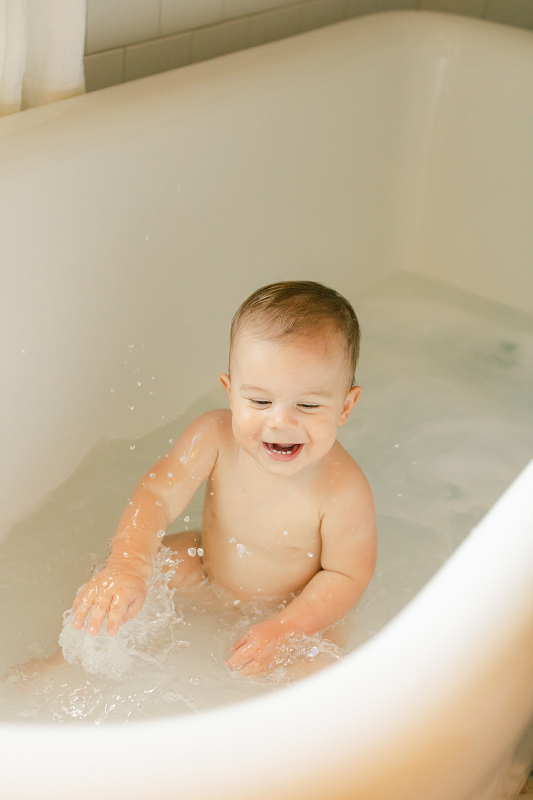 1 year milestone session for baby boy. Cozy at home session. baby in bathtub