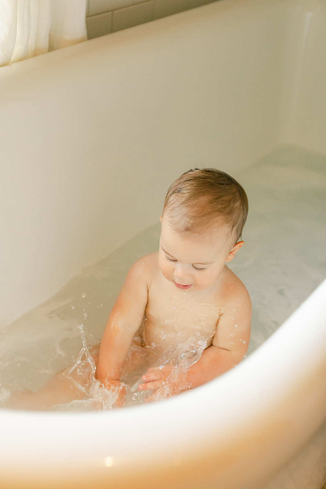 1 year milestone session for baby boy. Cozy at home session. baby boy in bathtub
