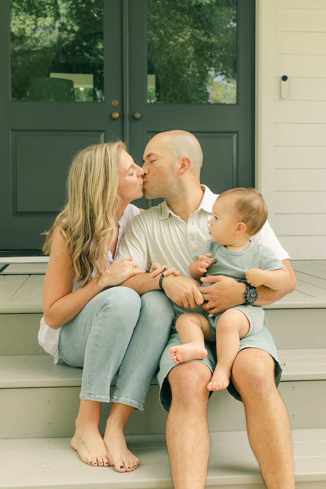1 year milestone session for baby boy. Cozy at home session. family sitting in front porch
