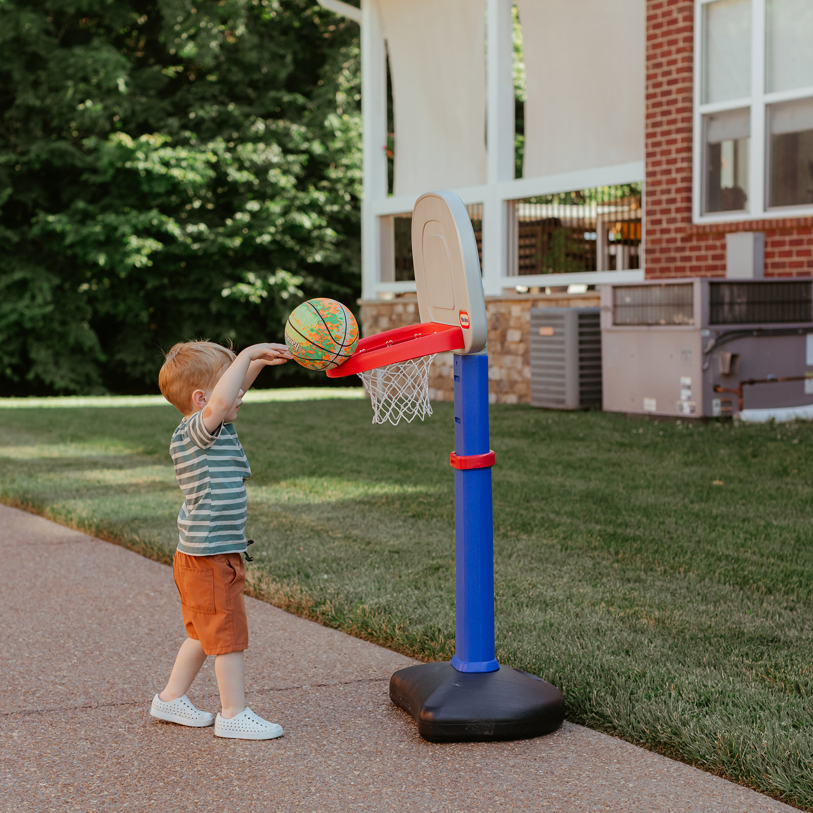 Little boy playing basketball. Backyard summer family session in Nashville, TN