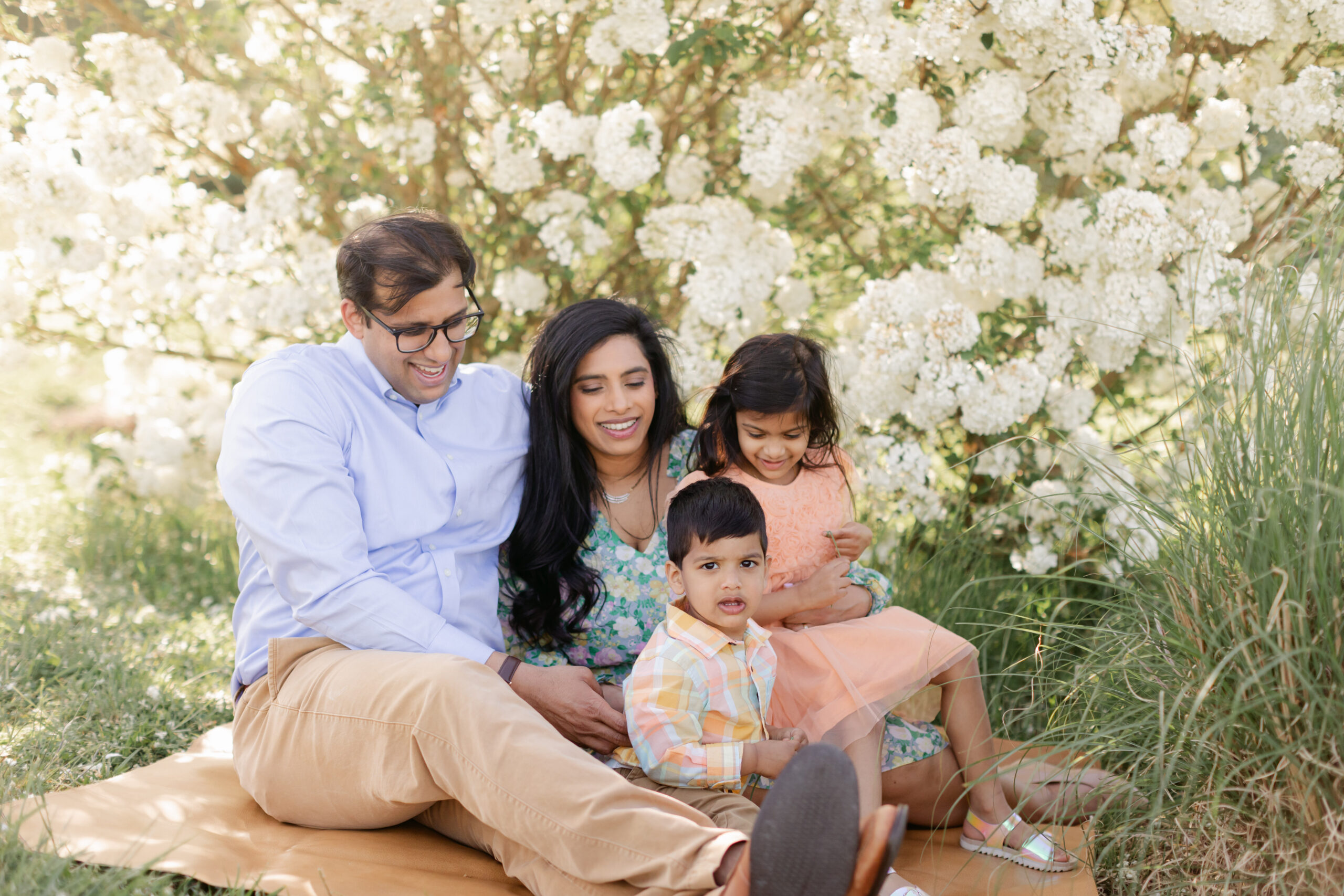 Family of four (mom, dad, first born toddler daughter and little boy) in coordinating spring outfits. Outdoor family photos in Nashville park. 