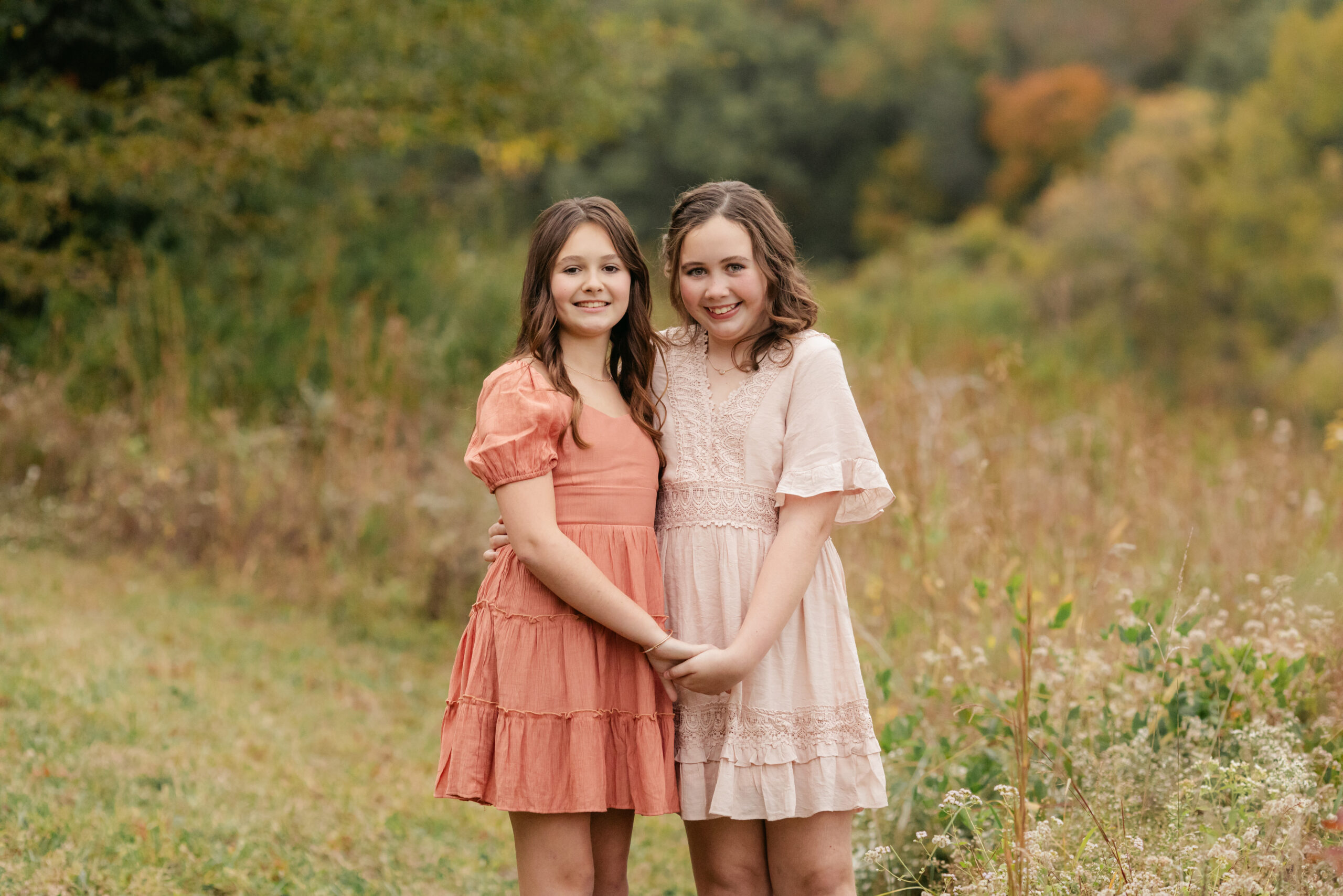 sisters during fall family photos at the woods