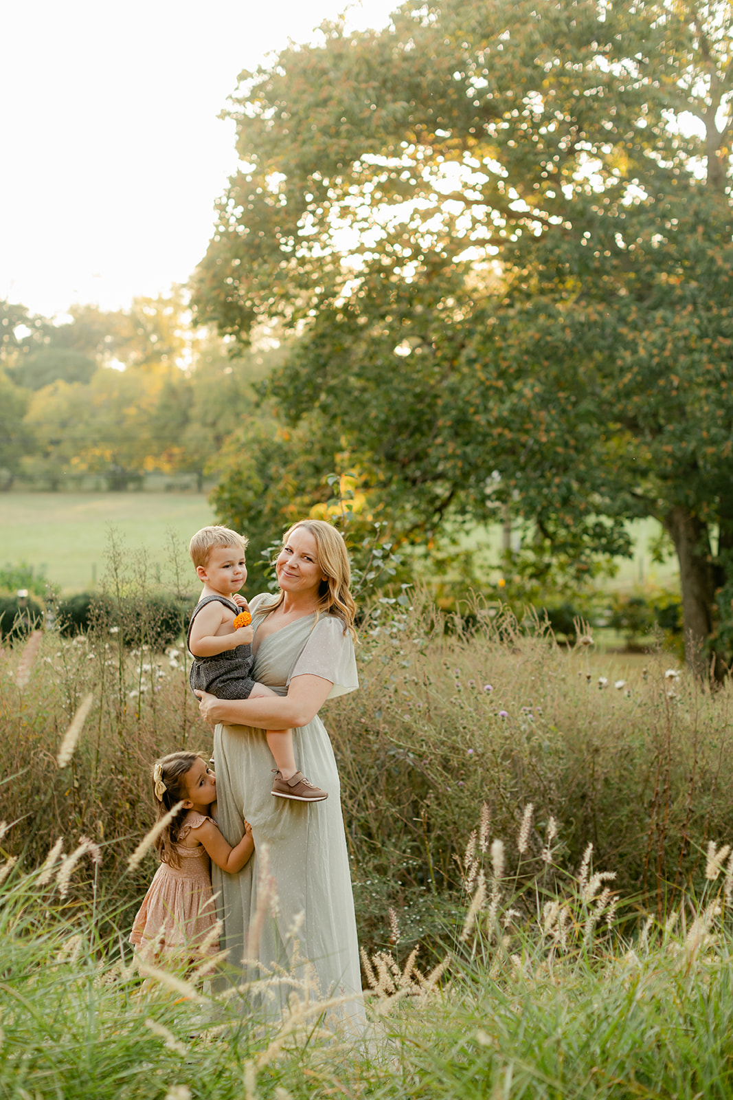 fall family photos at the art barn. mama with her two young kids (little boy, little girl)