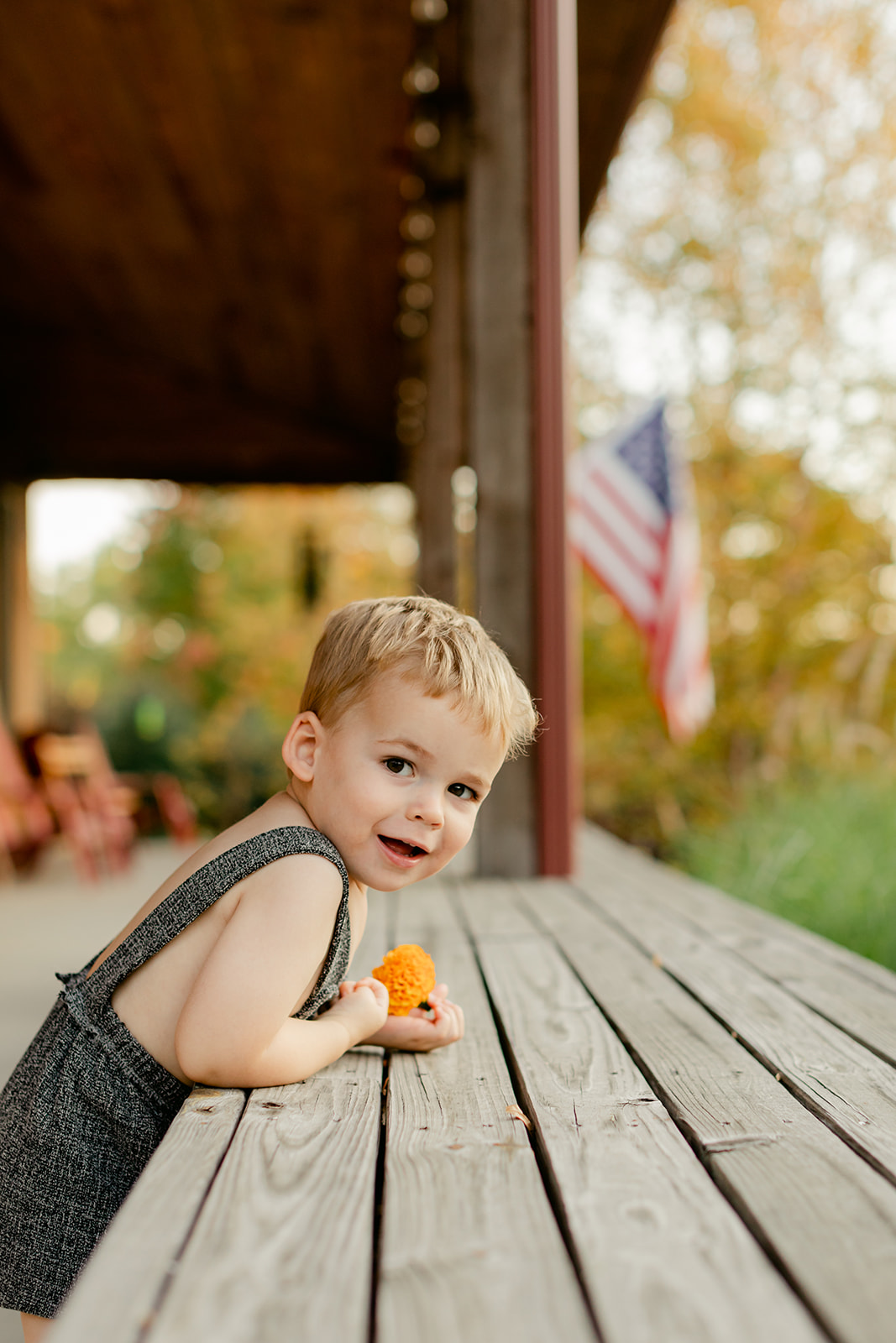 little boy during fall family photos at the art barn