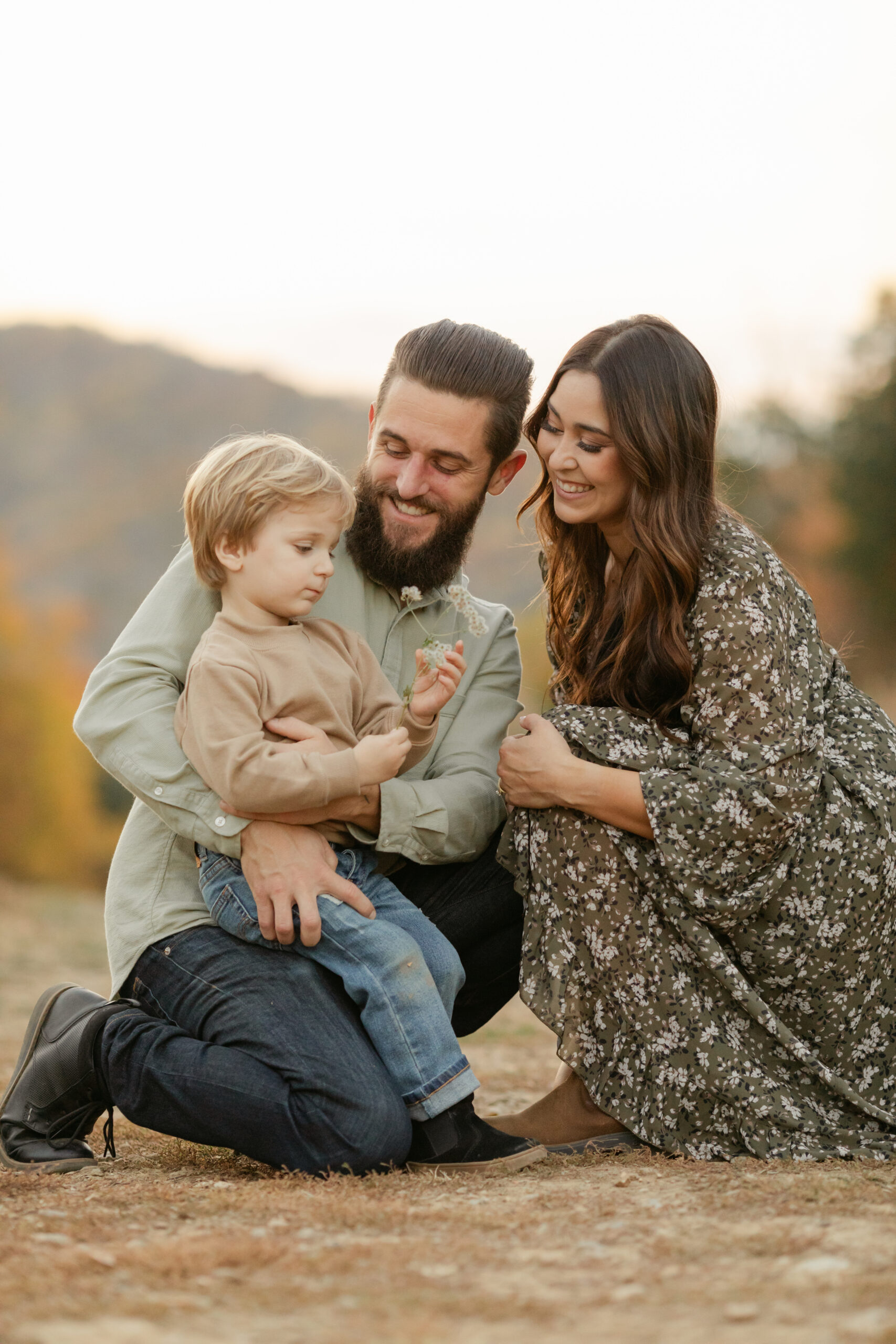 fall family photos at top of hill.