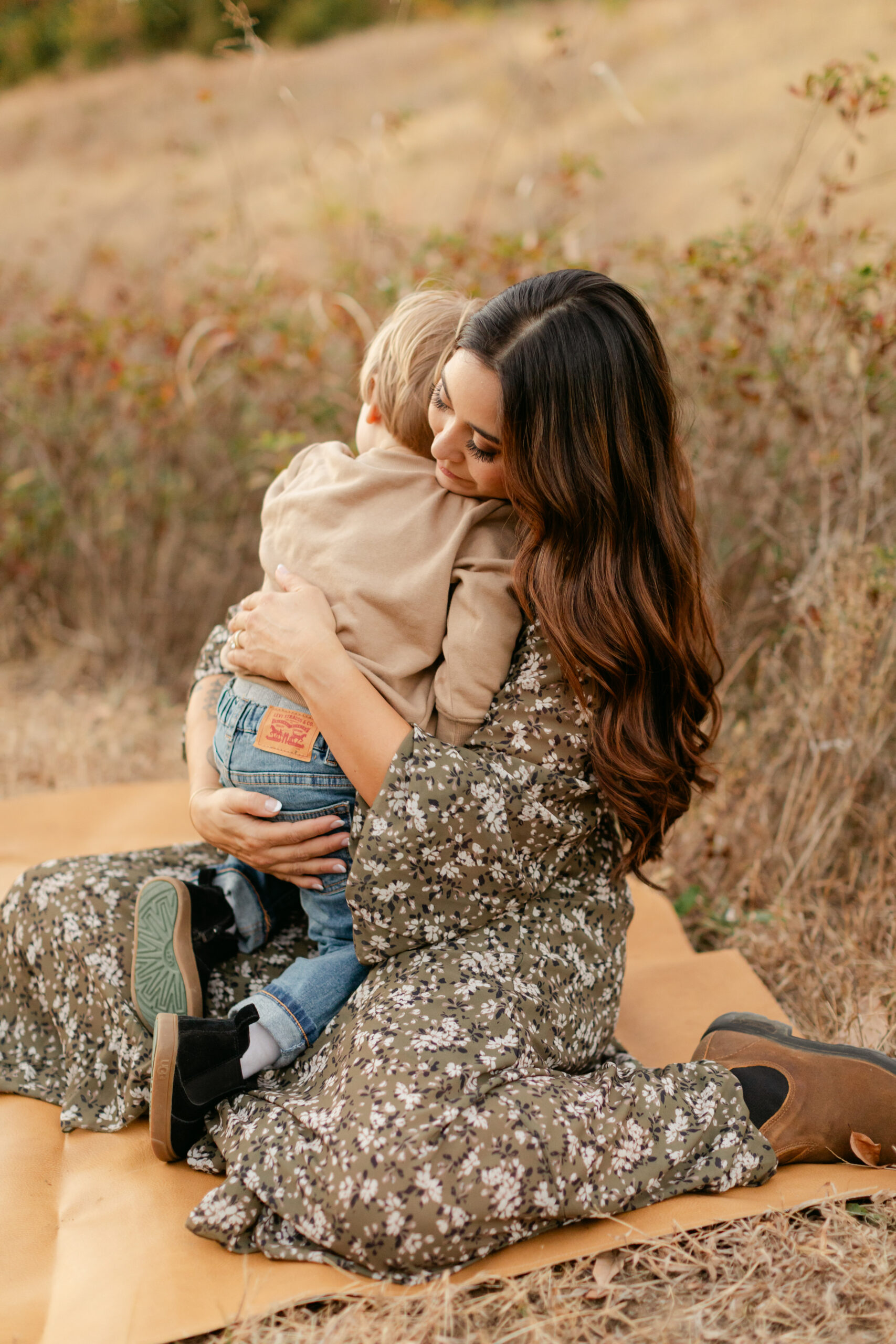 mama and toddler son at top of hill during fall family photos