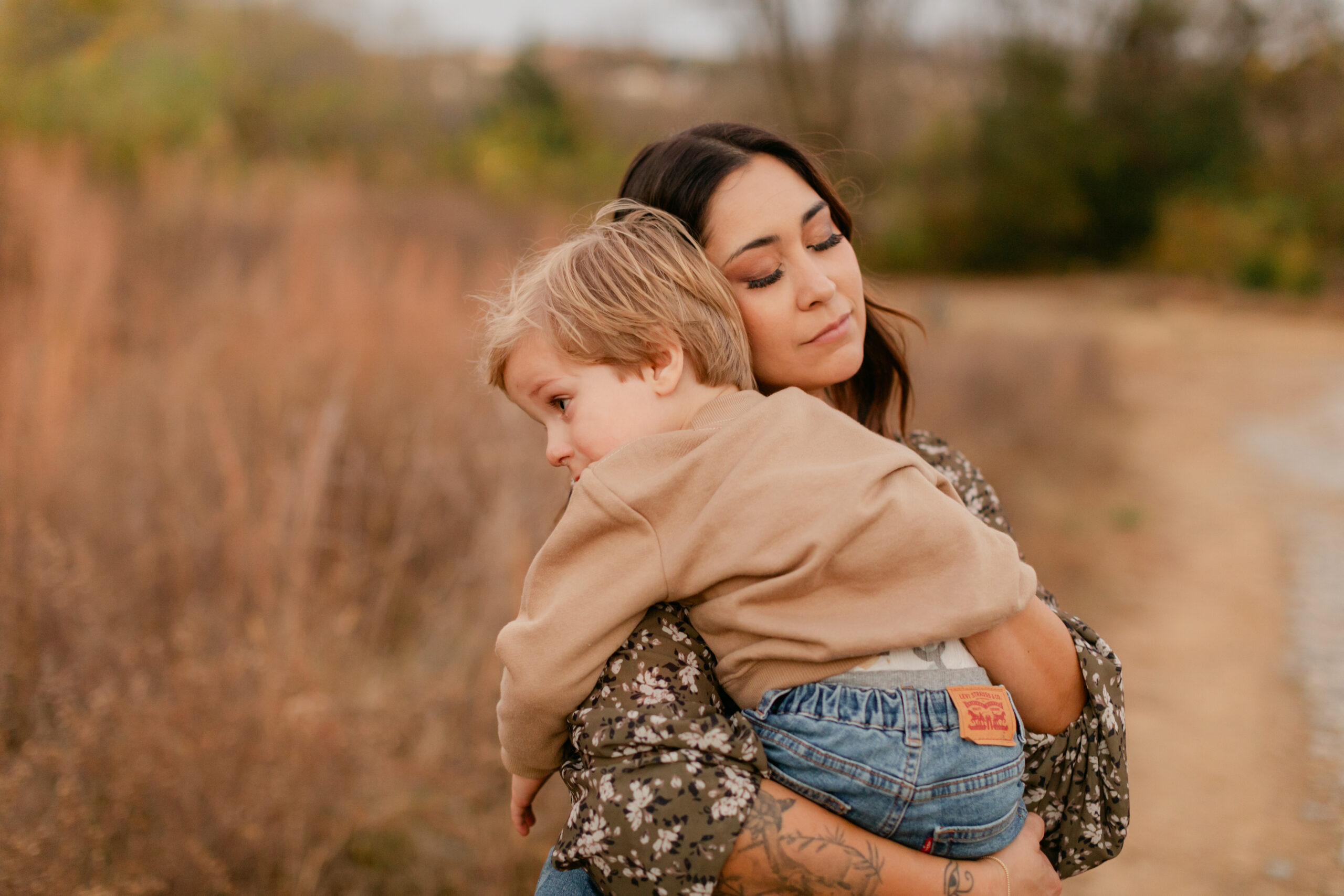 mama and toddler son at top of hill during fall family photos