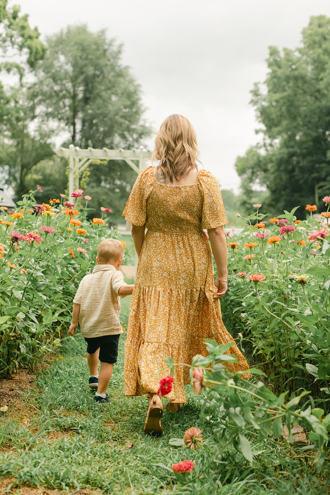 mama with toddler boy in garden during motherhood minis