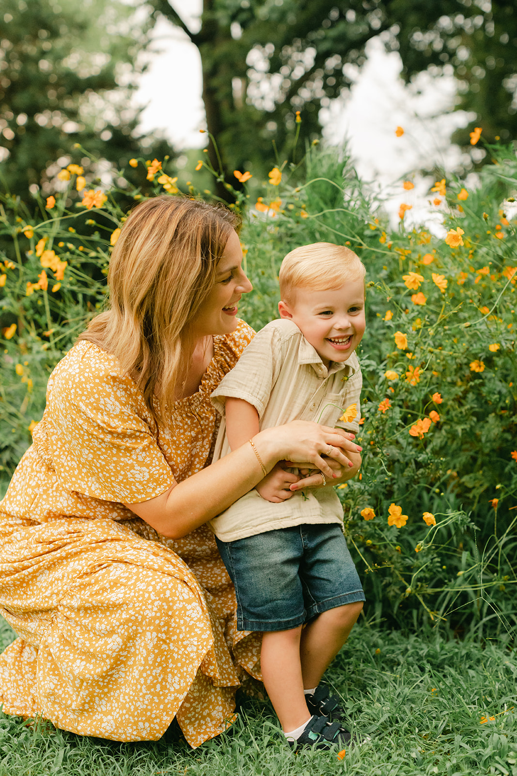 mama with toddler boy in garden during motherhood minis