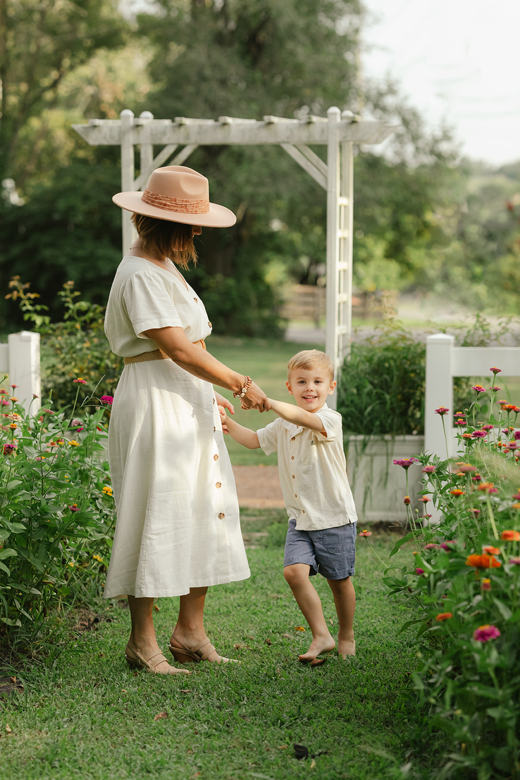 mama with toddler boy in garden during motherhood minis