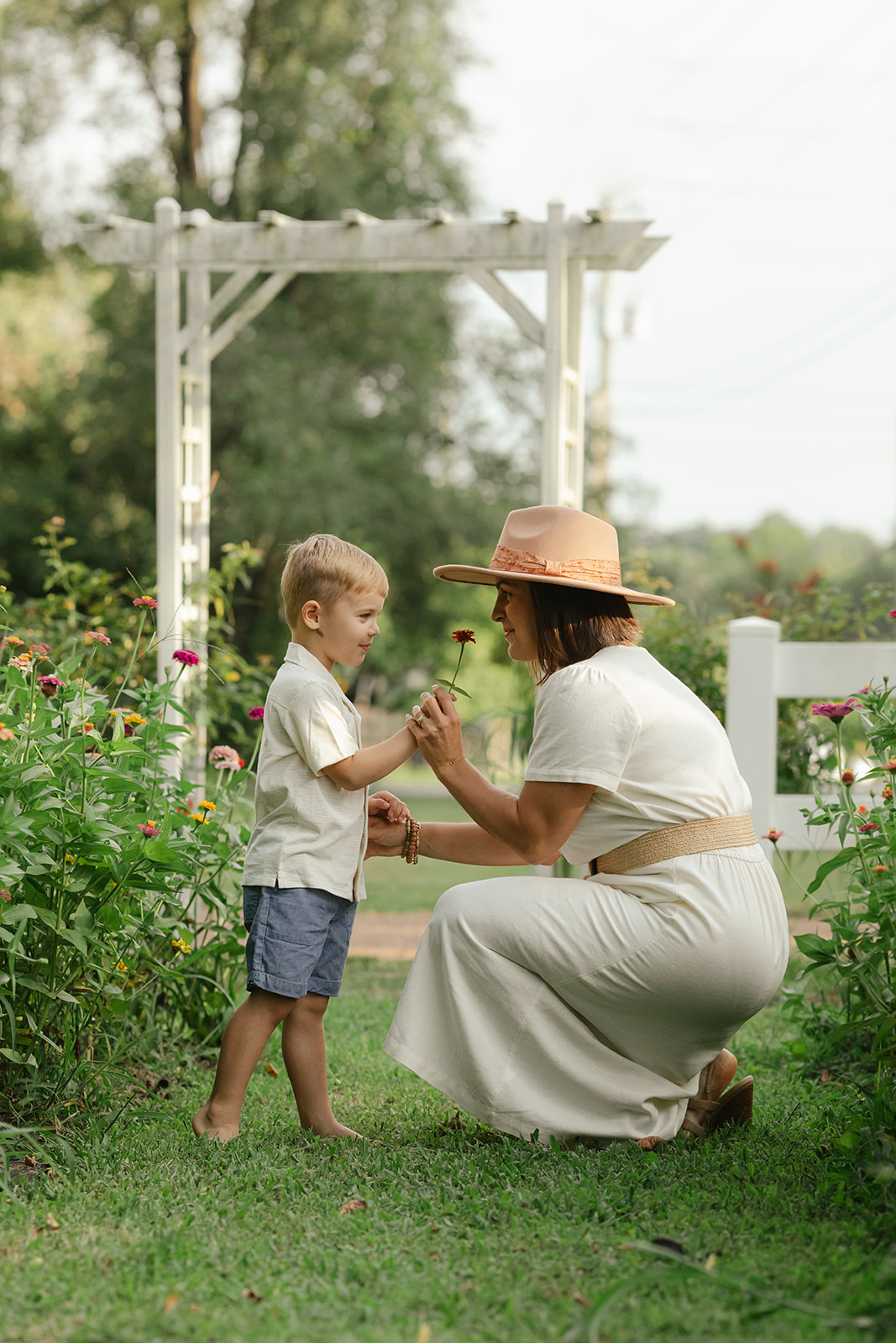 mama with toddler boy in garden during motherhood minis