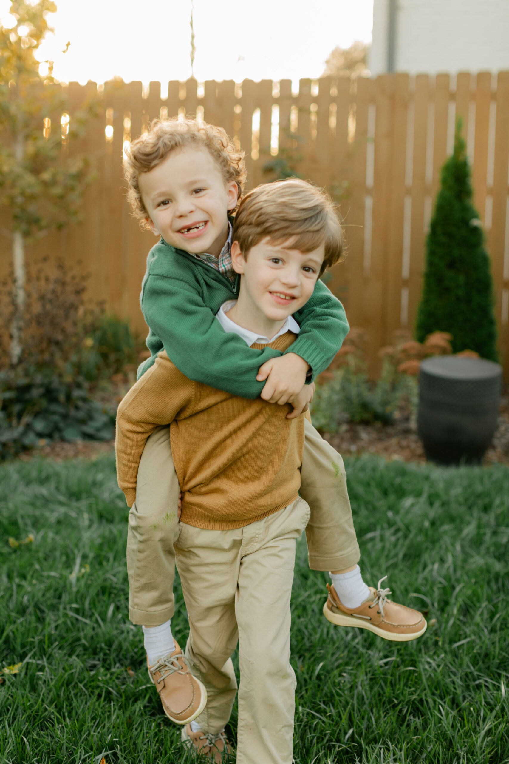 two brothers during fall family photos in their home backyard