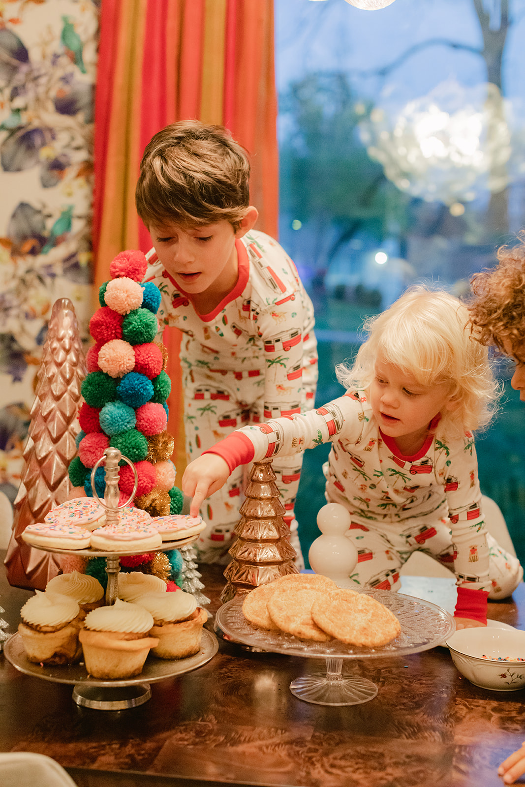 kids in Christmas pj's baking cookies. Christmas family photos in home