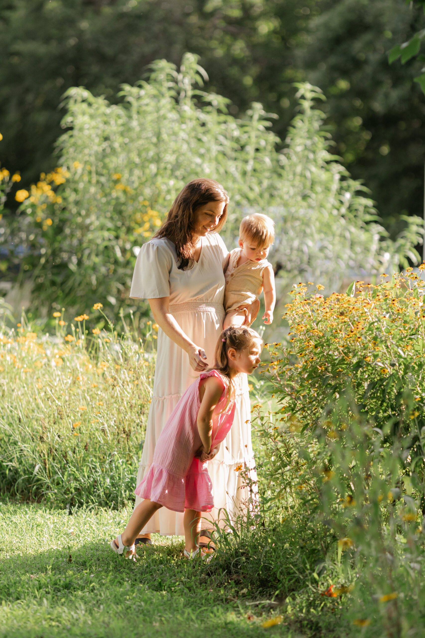 mama and young daughter and son in flower garden. motherhood minis photo session in nashville