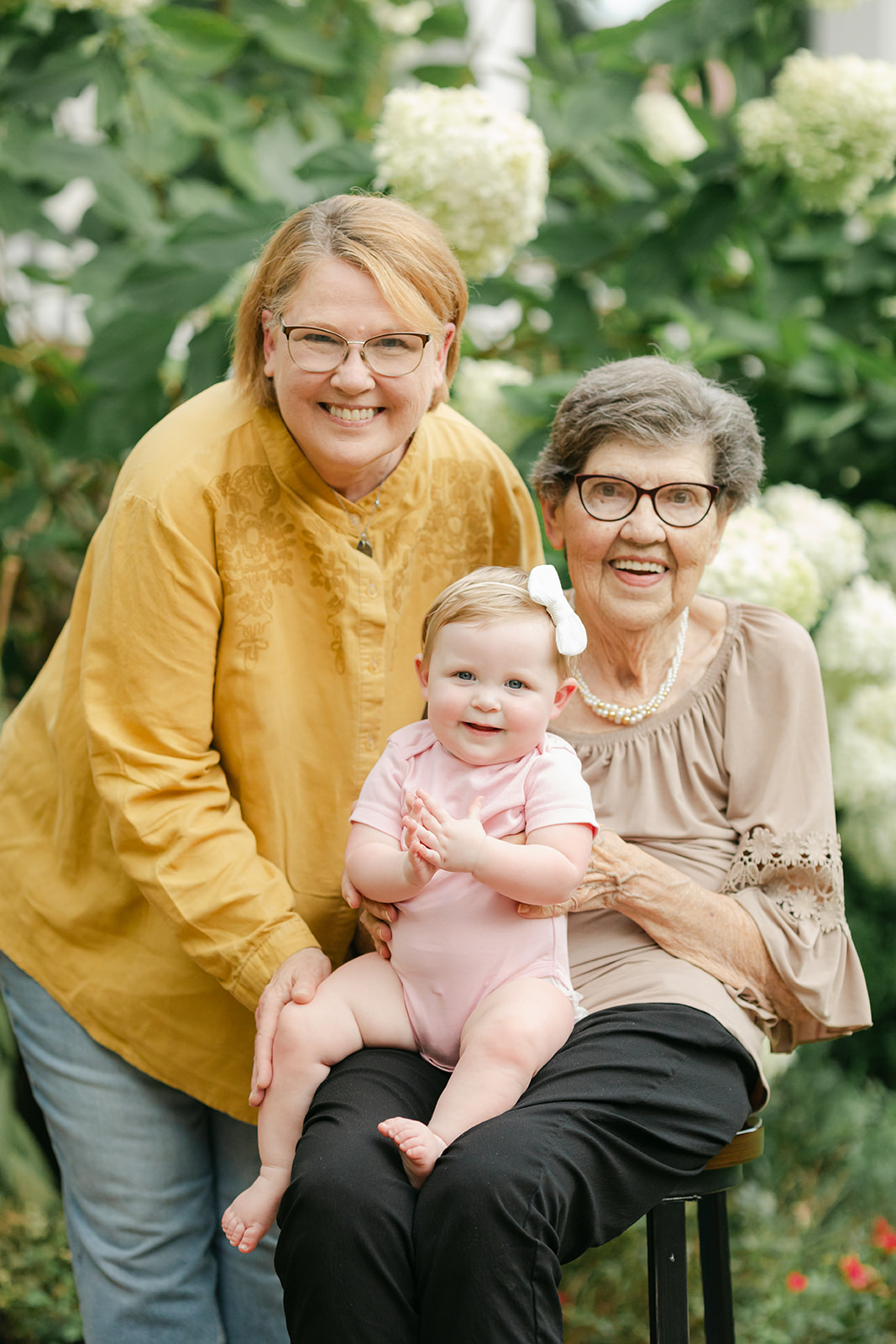 Grandmothers with baby girl in flower garden. motherhood minis photo session in nashville