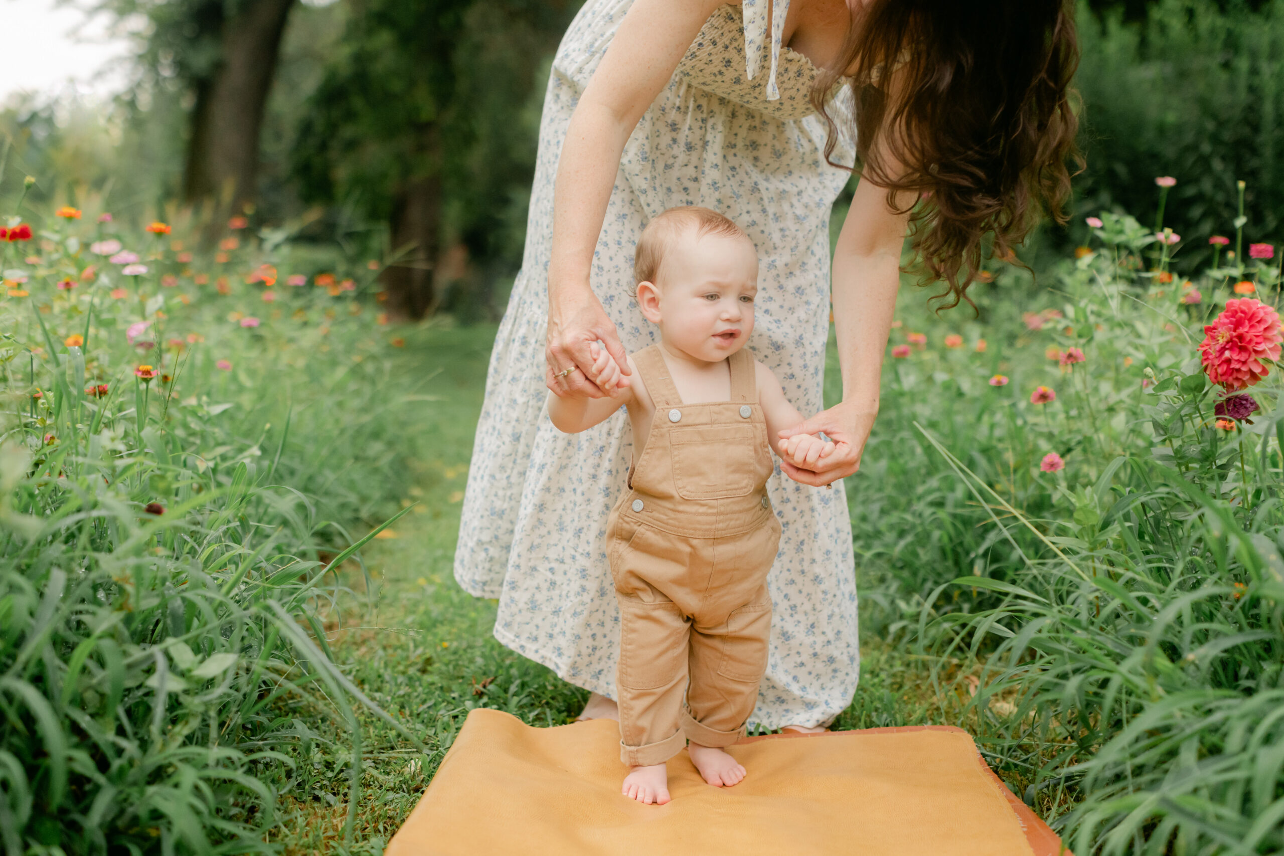 Mom with young son in flower garden. motherhood minis photo session in nashville