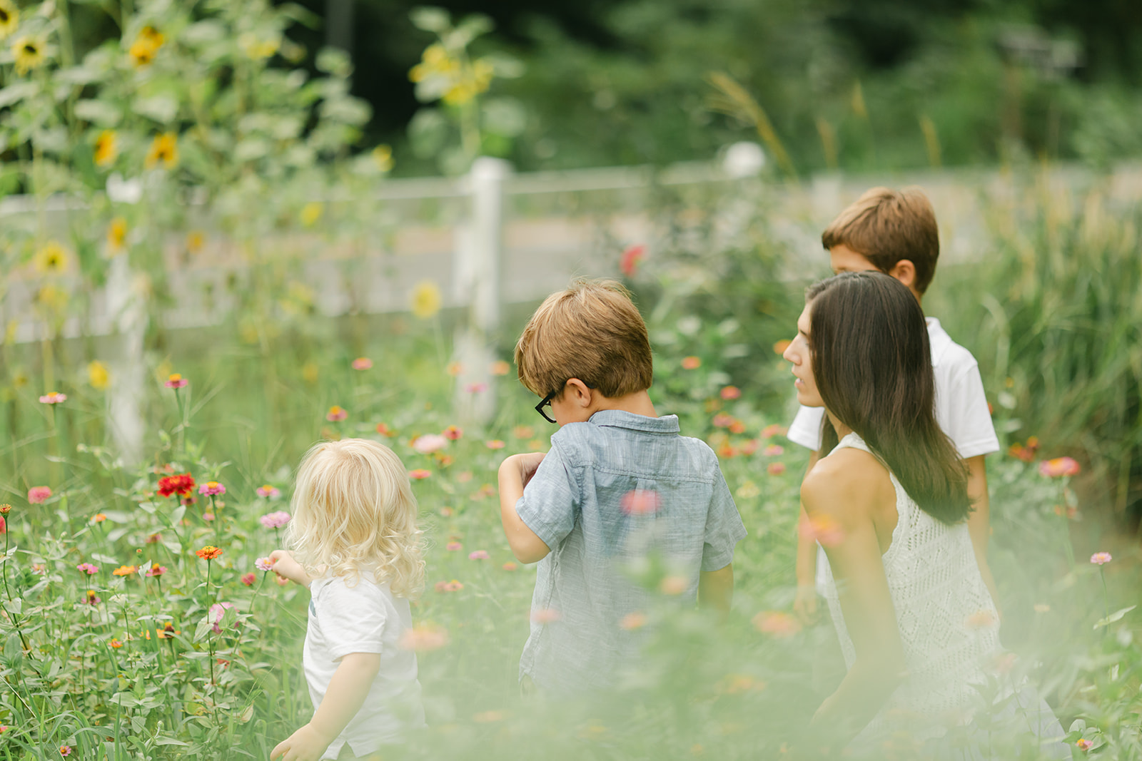 Mom with her three young boys in flower garden. motherhood minis photo session in nashville