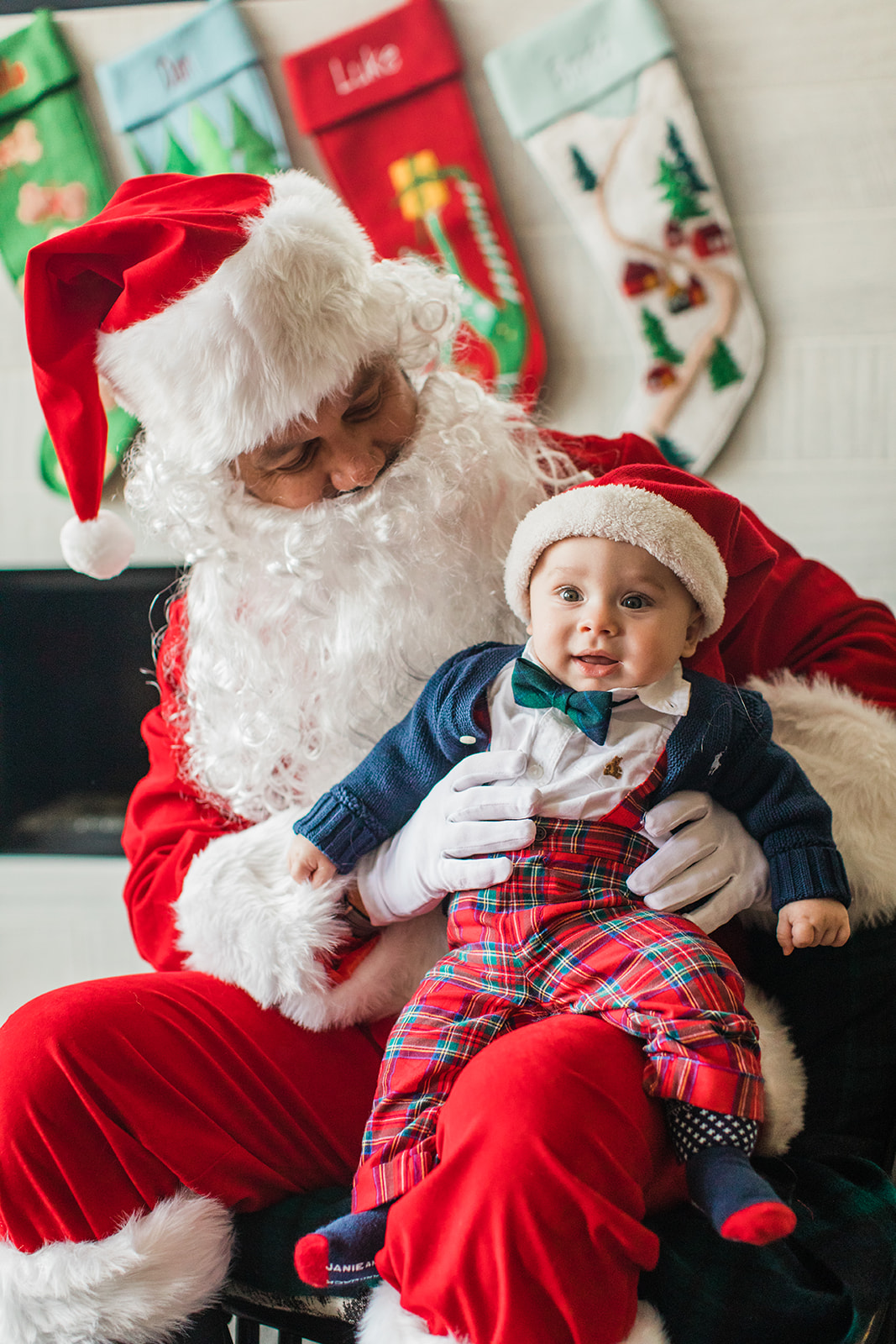 dad dressed up as Santa Claus . christmas family photos in living room