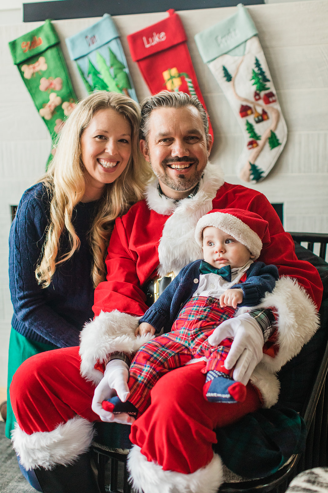 dad dressed up as Santa Claus . christmas family photos in living room