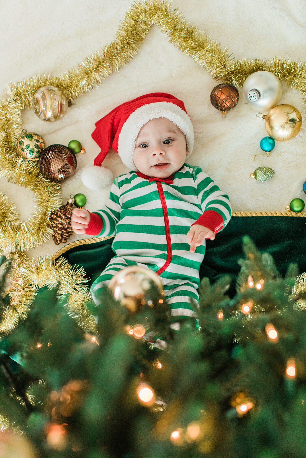 baby boy in christmas onesie. christmas family photos in living room