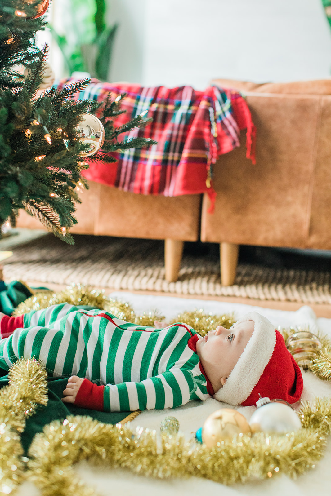 baby boy in christmas onesie. christmas family photos in living room