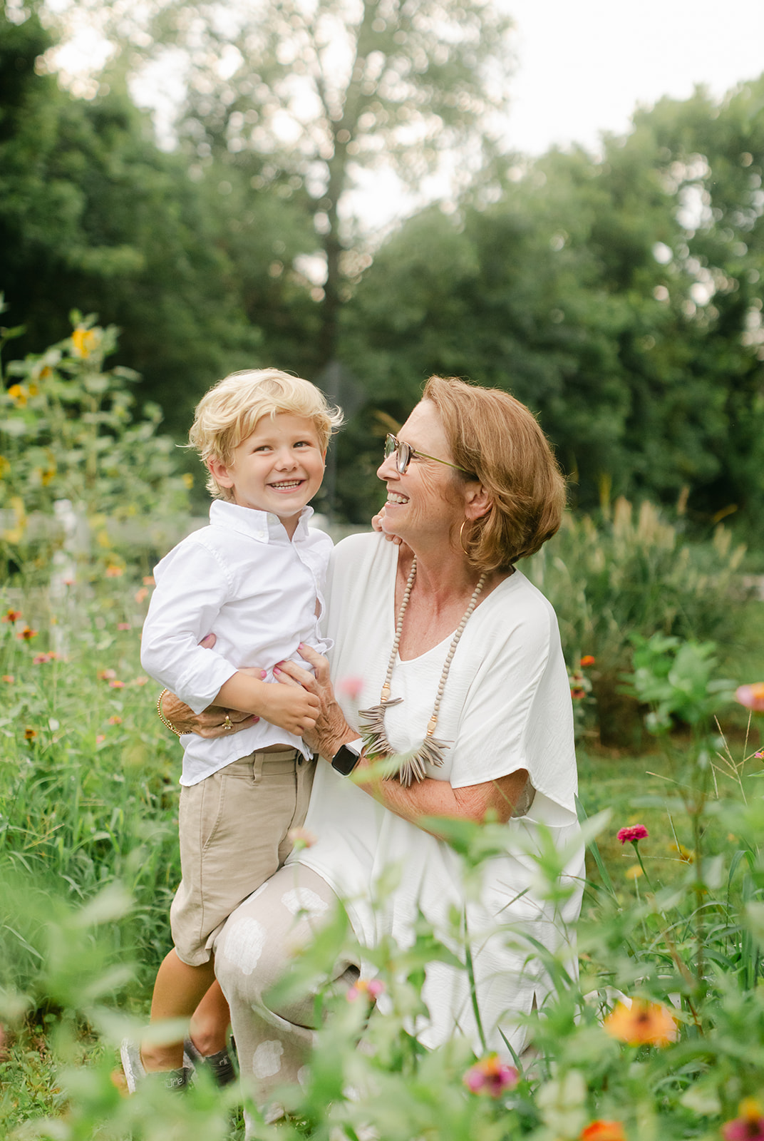 grandma and young grandson in flower garden. motherhood minis photo session in nashville