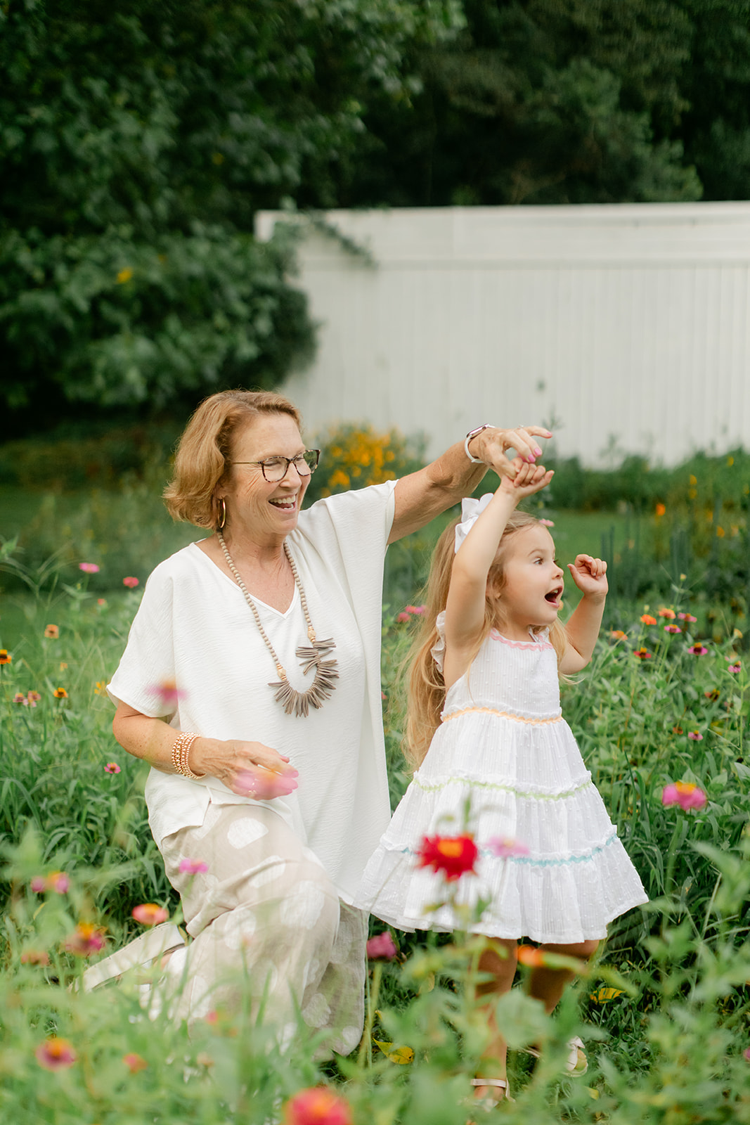 grandma and young granddaughter in flower garden. motherhood minis photo session in nashville