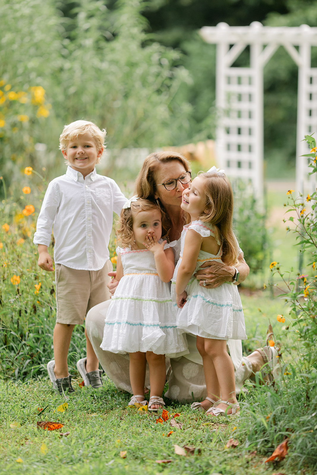 Granma with grandchildren in flower garden. motherhood minis photo session in nashville