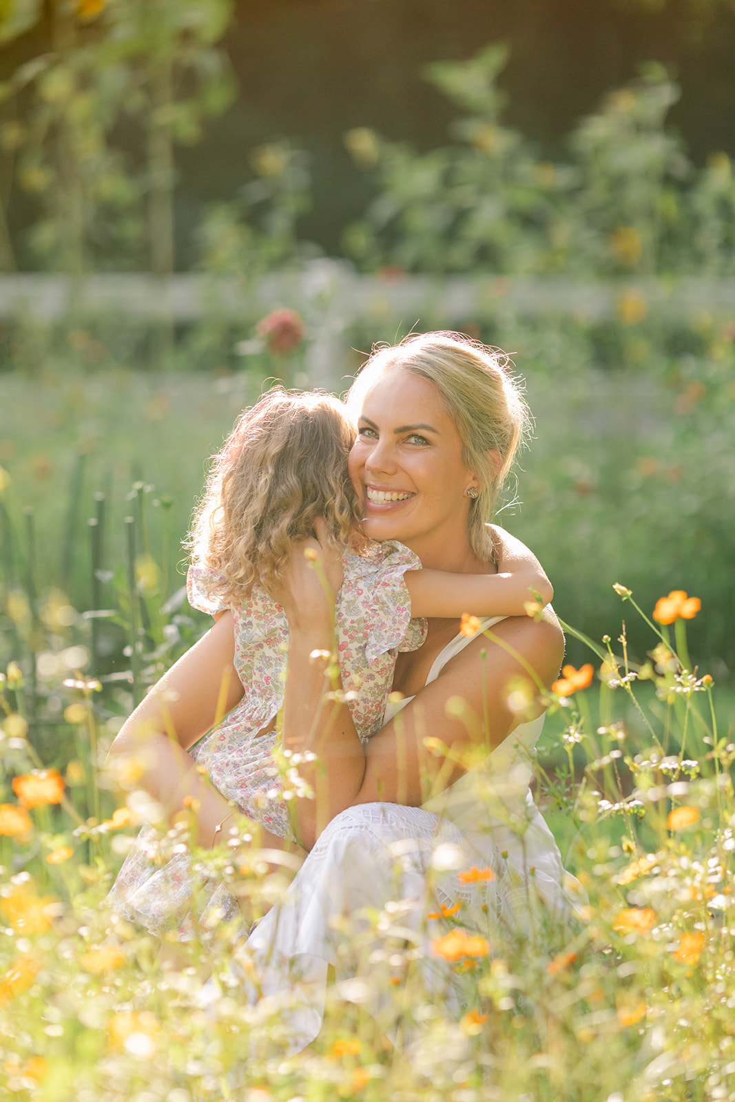 Mom with young daughter in flower garden. motherhood minis photo session in nashville