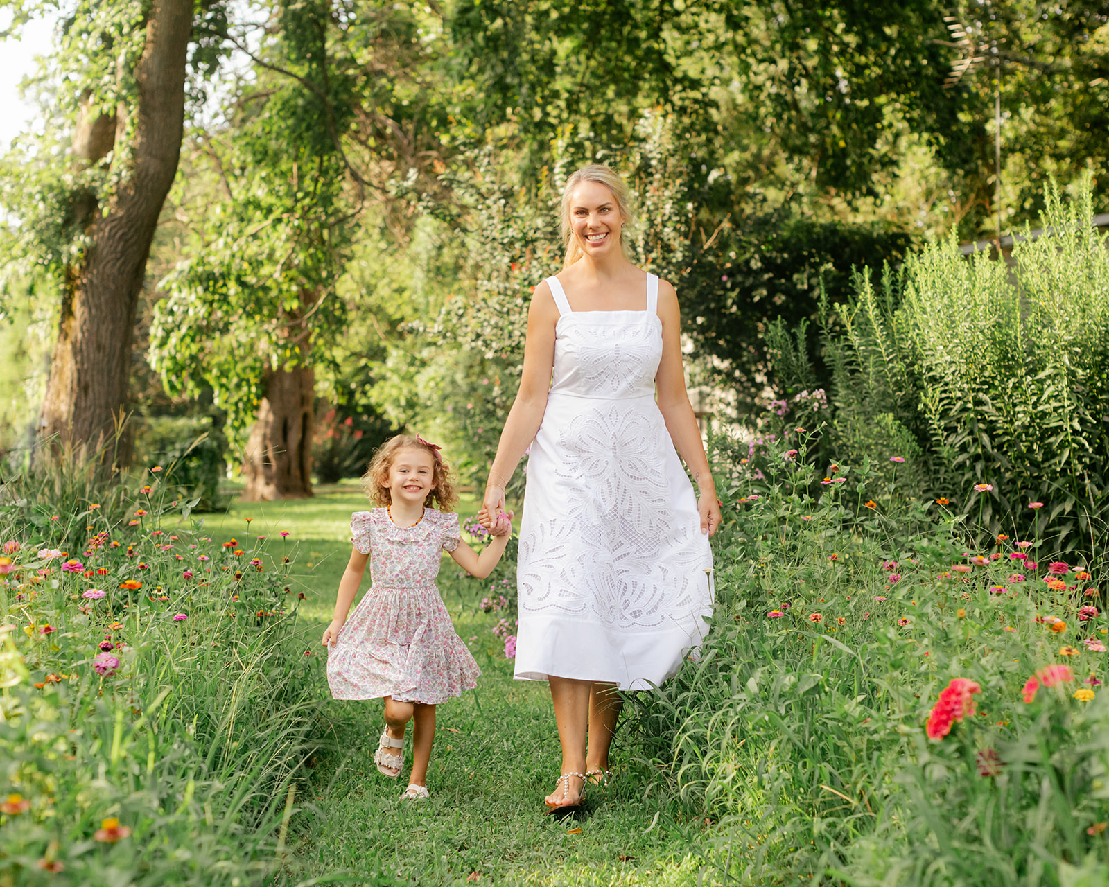 Mom with young daughter in flower garden. motherhood minis photo session in nashville