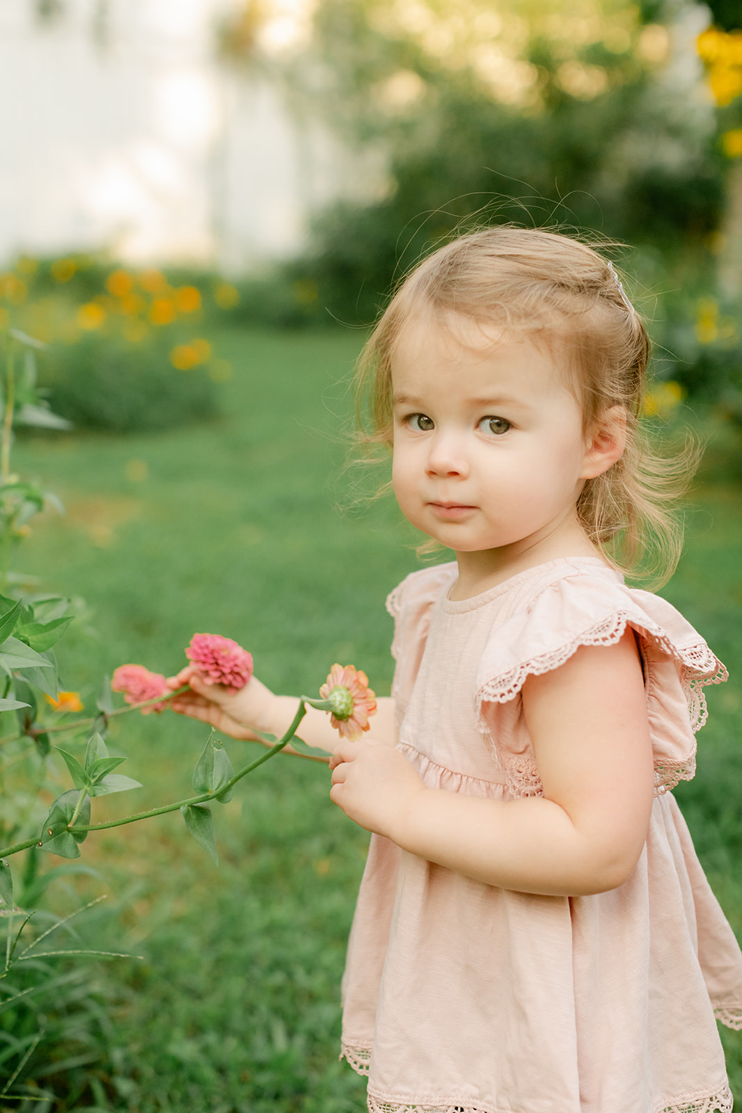 Baby girl in flower garden. motherhood minis photo session in nashville