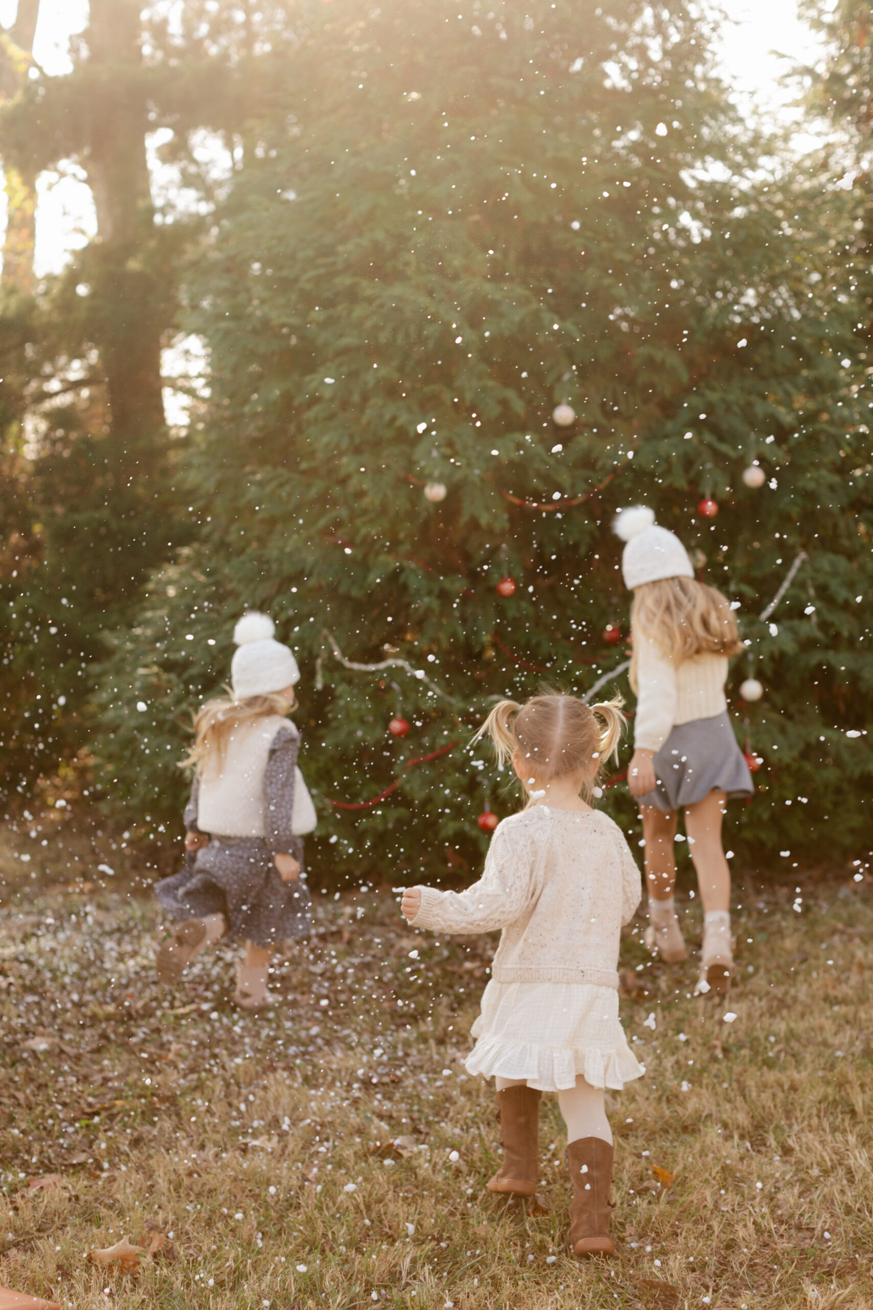 3 little sisters. christmas themed family photos in tennessee with fake snow