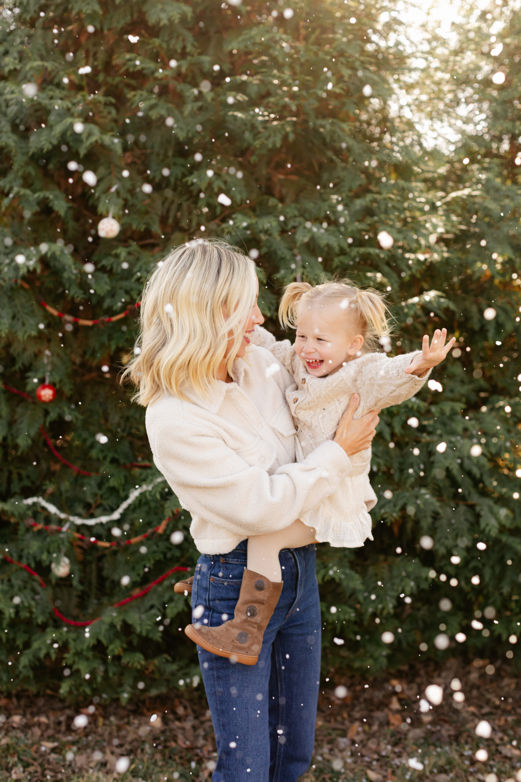 mom and young daughter. christmas themed family photos in tennessee with fake snow