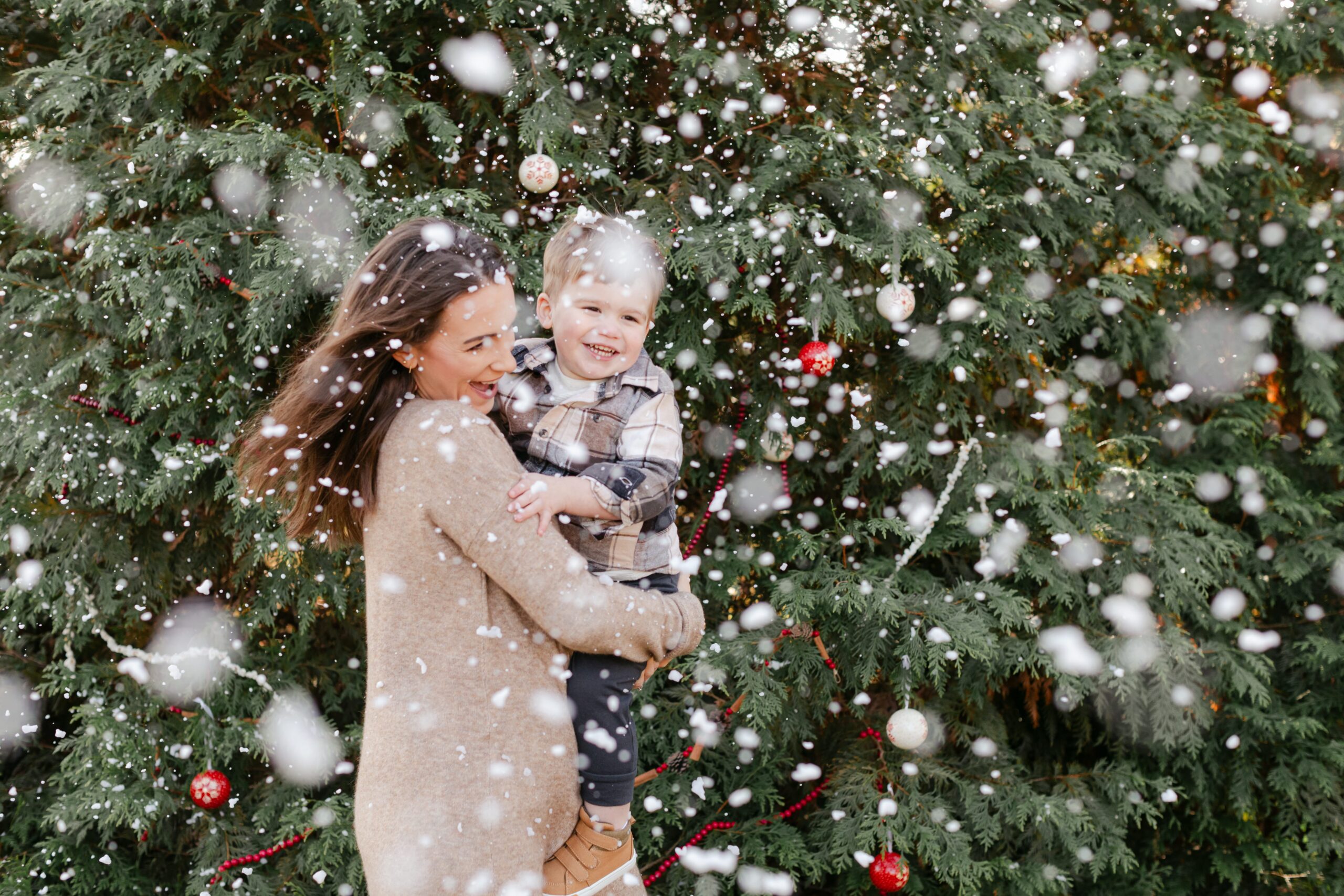 mom with baby boy.  christmas themed family photos in tennessee with fake snow