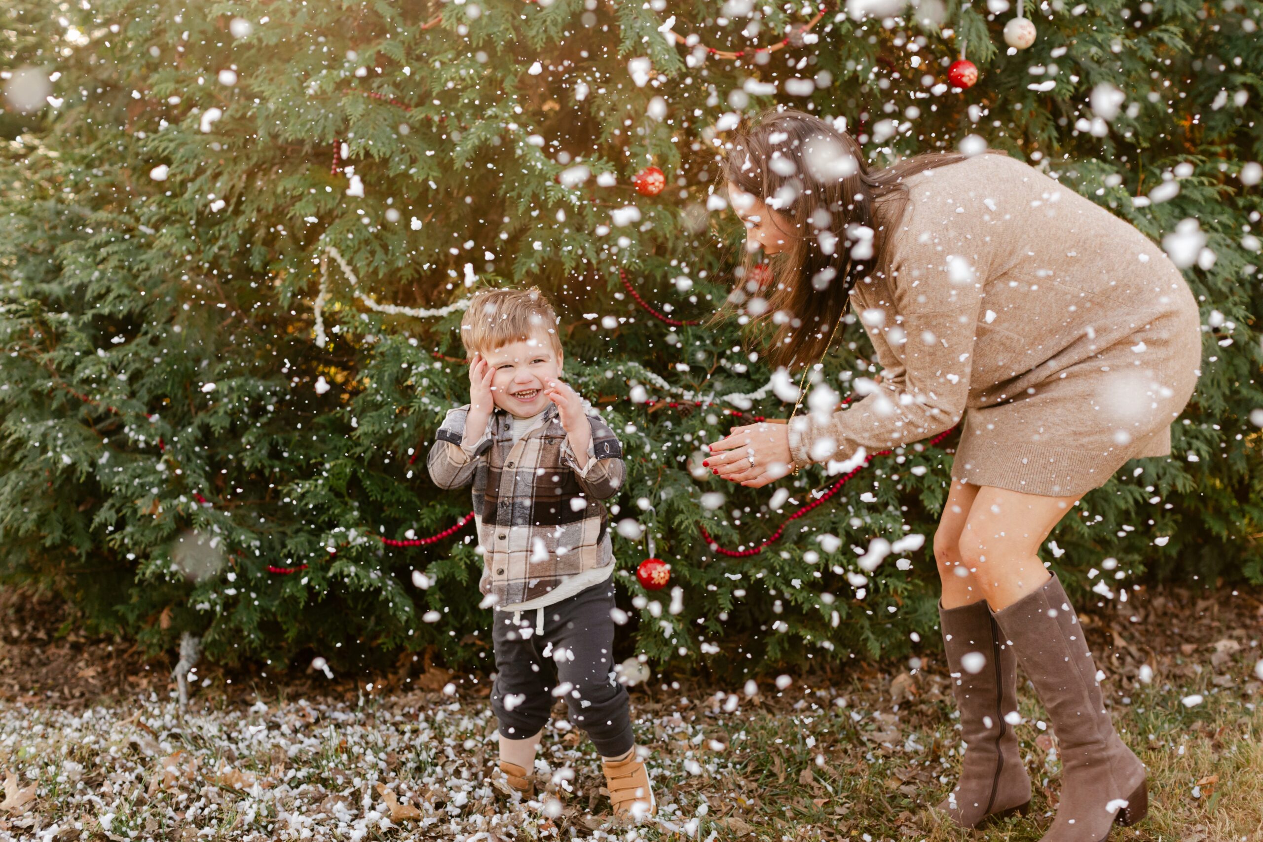 mom with young son.  christmas themed family photos in tennessee with fake snow