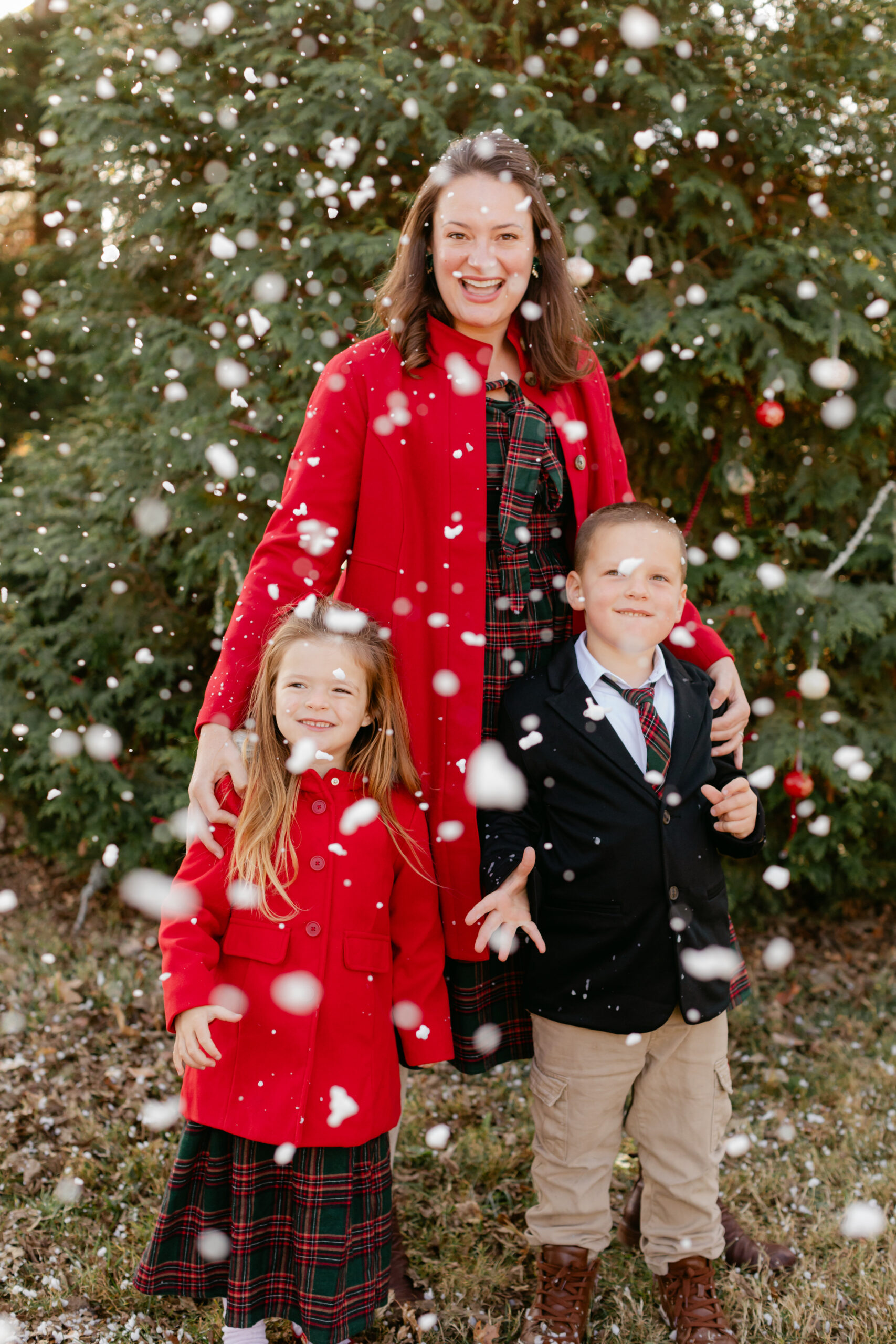 mom with young daughter and son.  christmas themed family photos in tennessee with fake snow