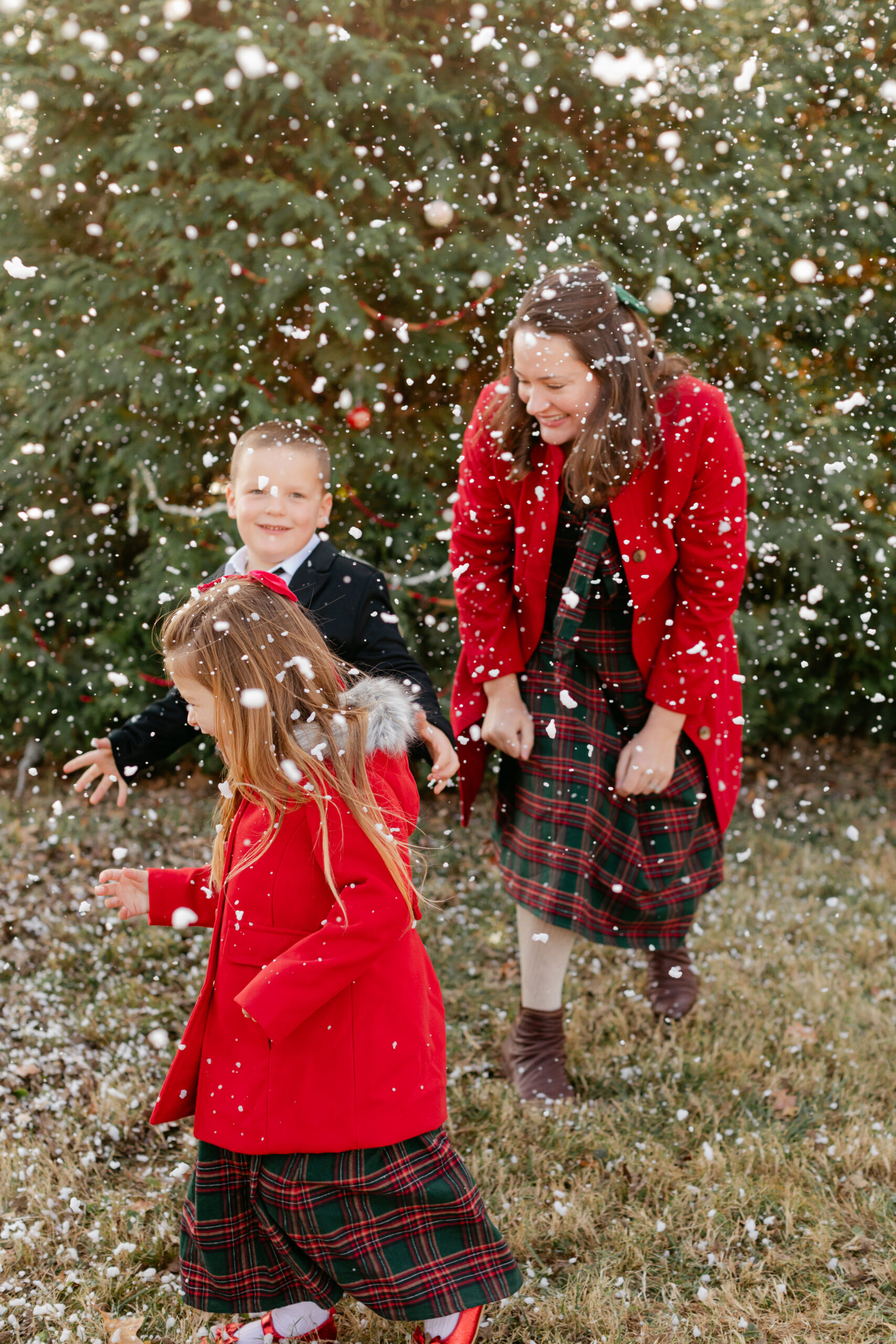 mom with her two kids.  christmas themed family photos in tennessee with fake snow