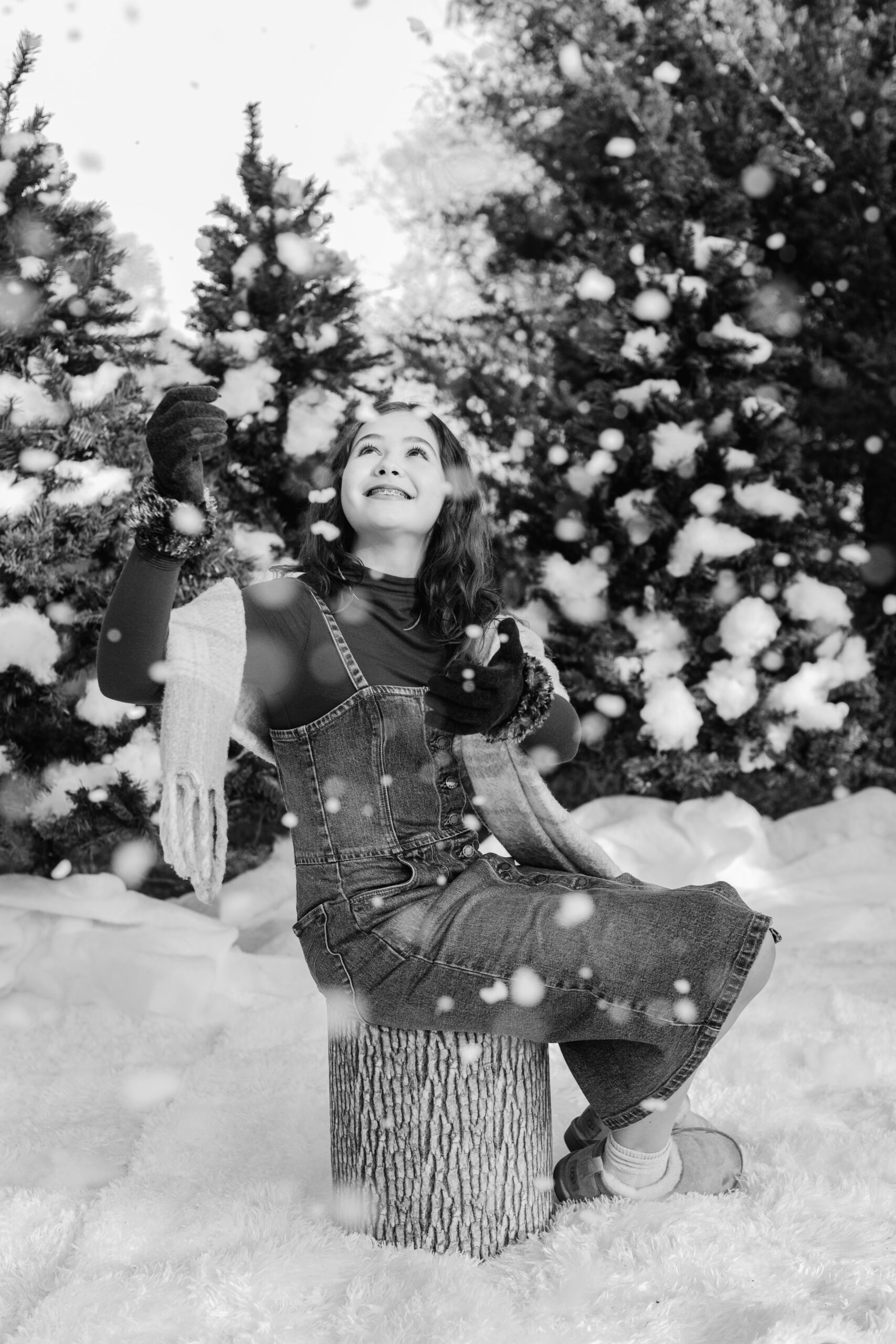 young teen girl in cute winter outfit playing with fake snow during snow minis