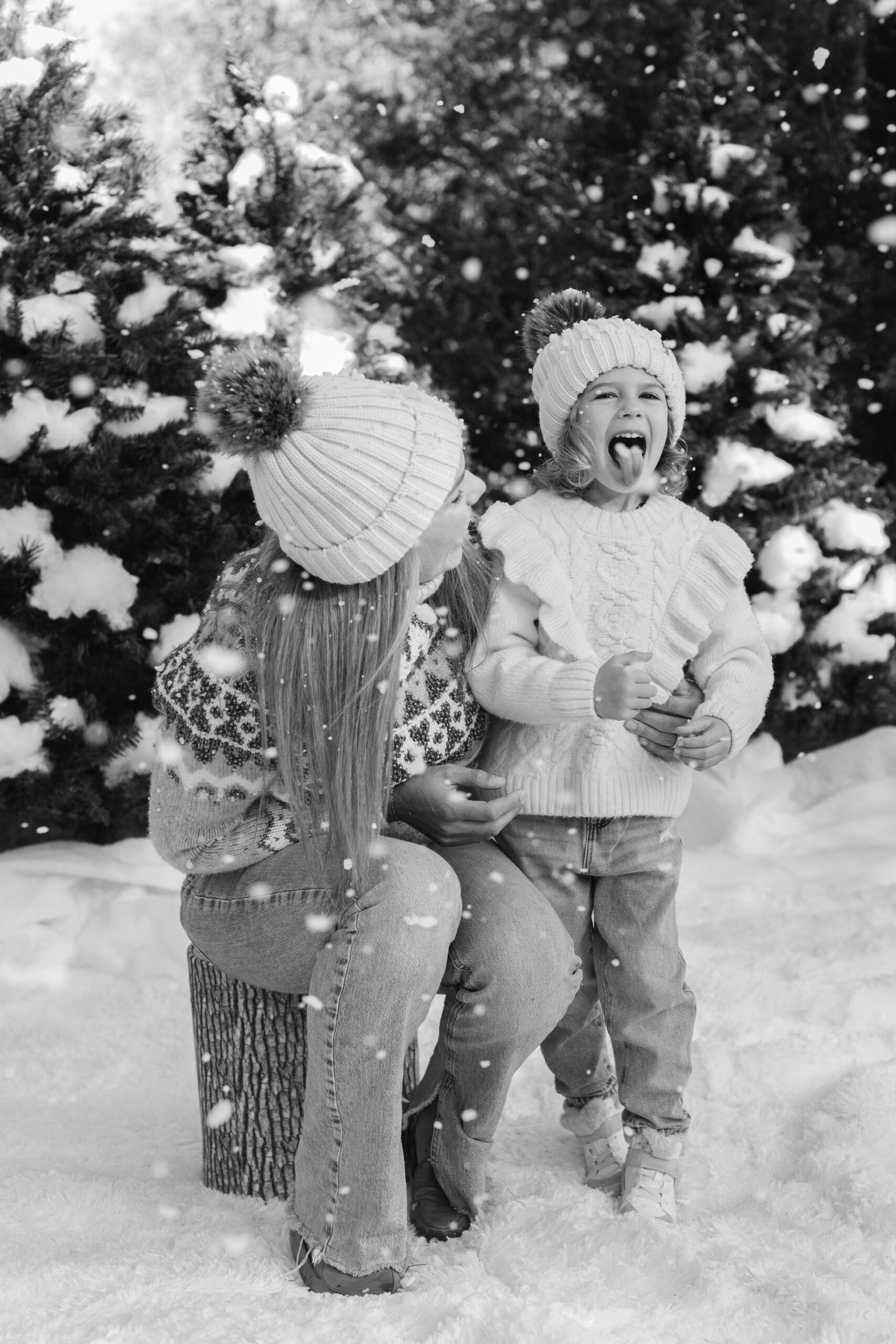 mom and daughter during snow minis christmas family photos