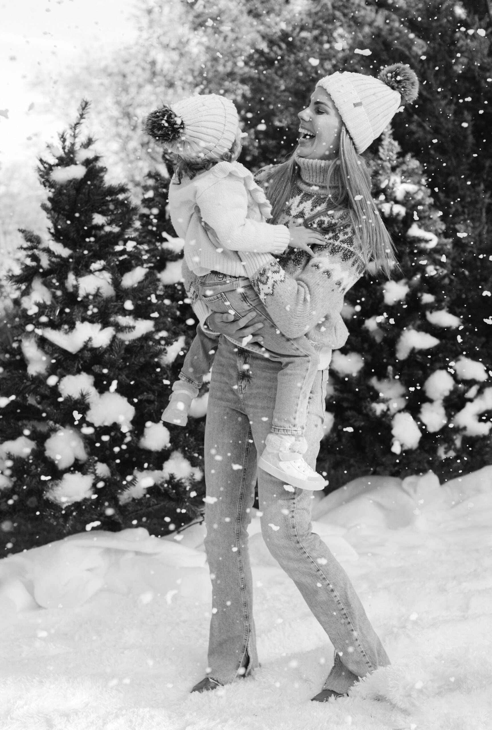 mom and daughter during snow minis christmas family photos