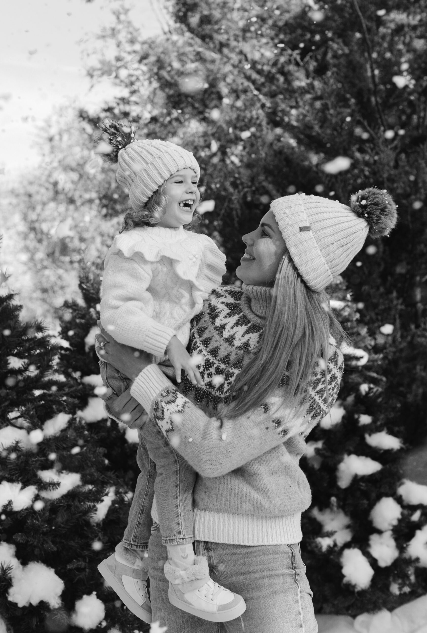 mom and daughter during snow minis christmas family photos