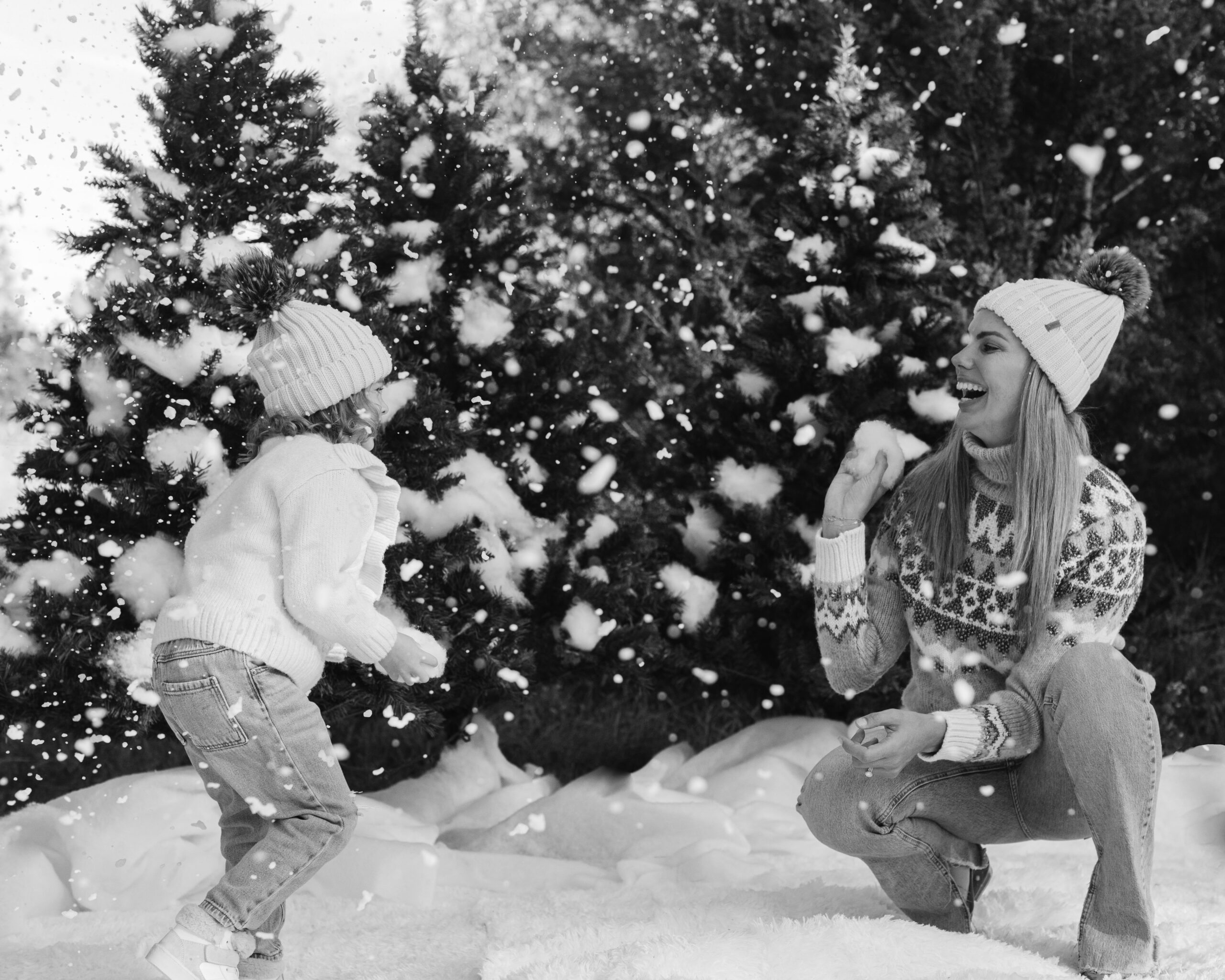 mom and daughter during snow minis christmas family photos