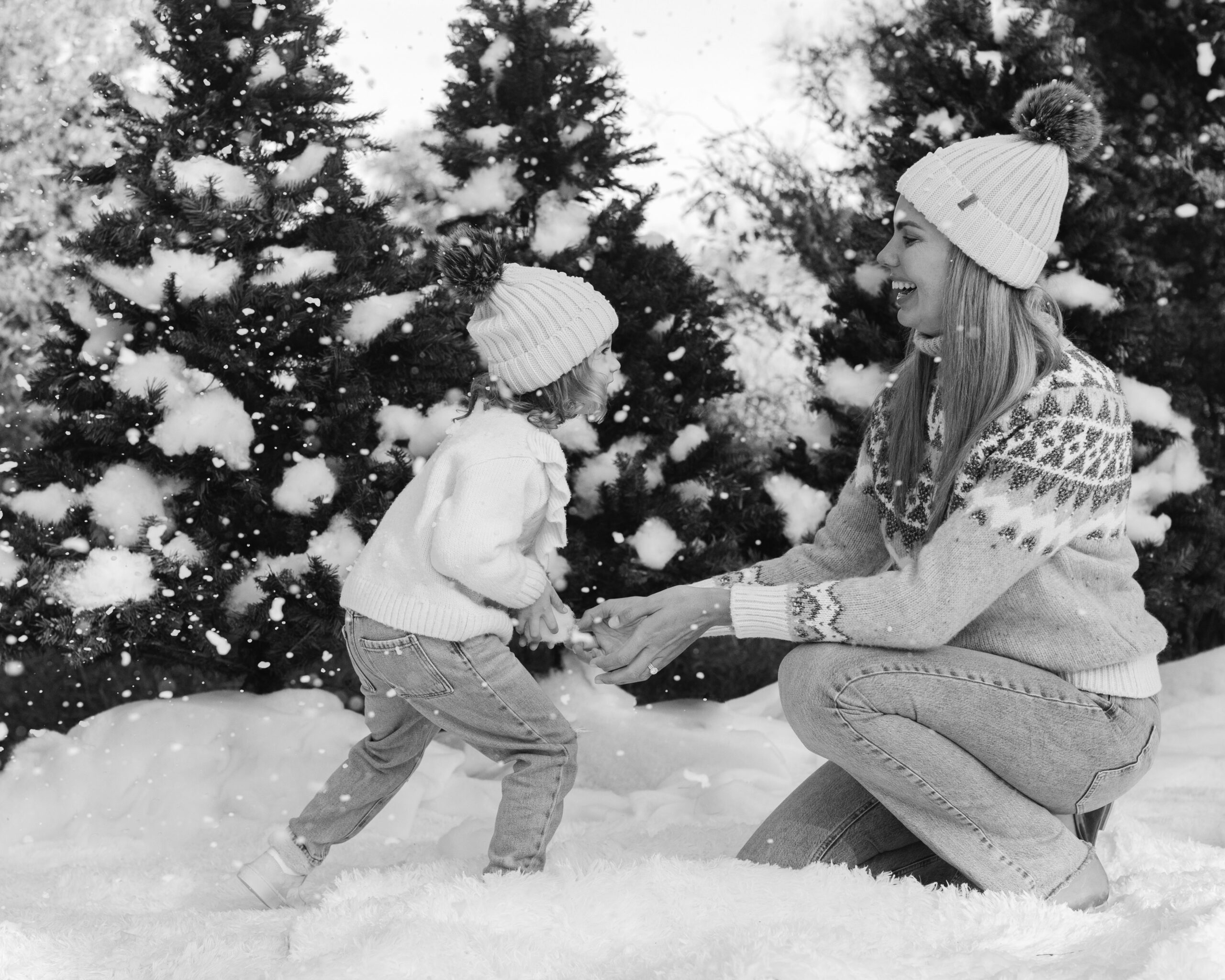 mom and daughter during snow minis christmas family photos