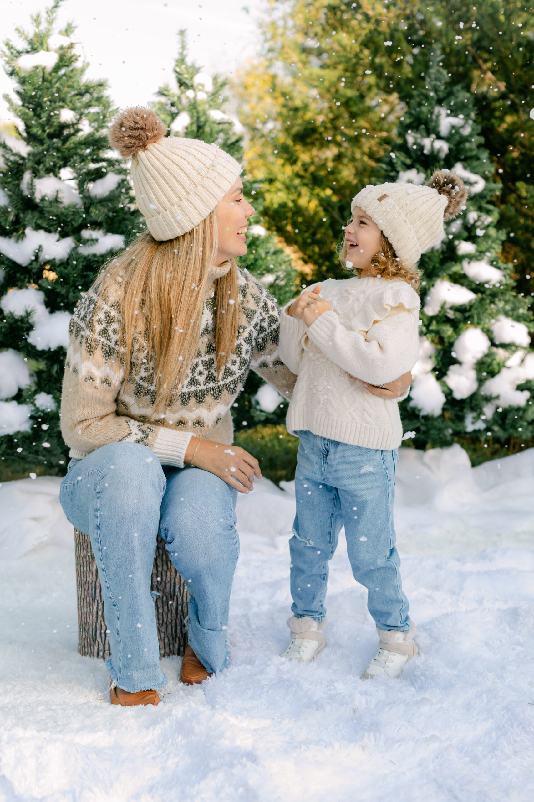 mom and daughter during snow minis christmas family photos